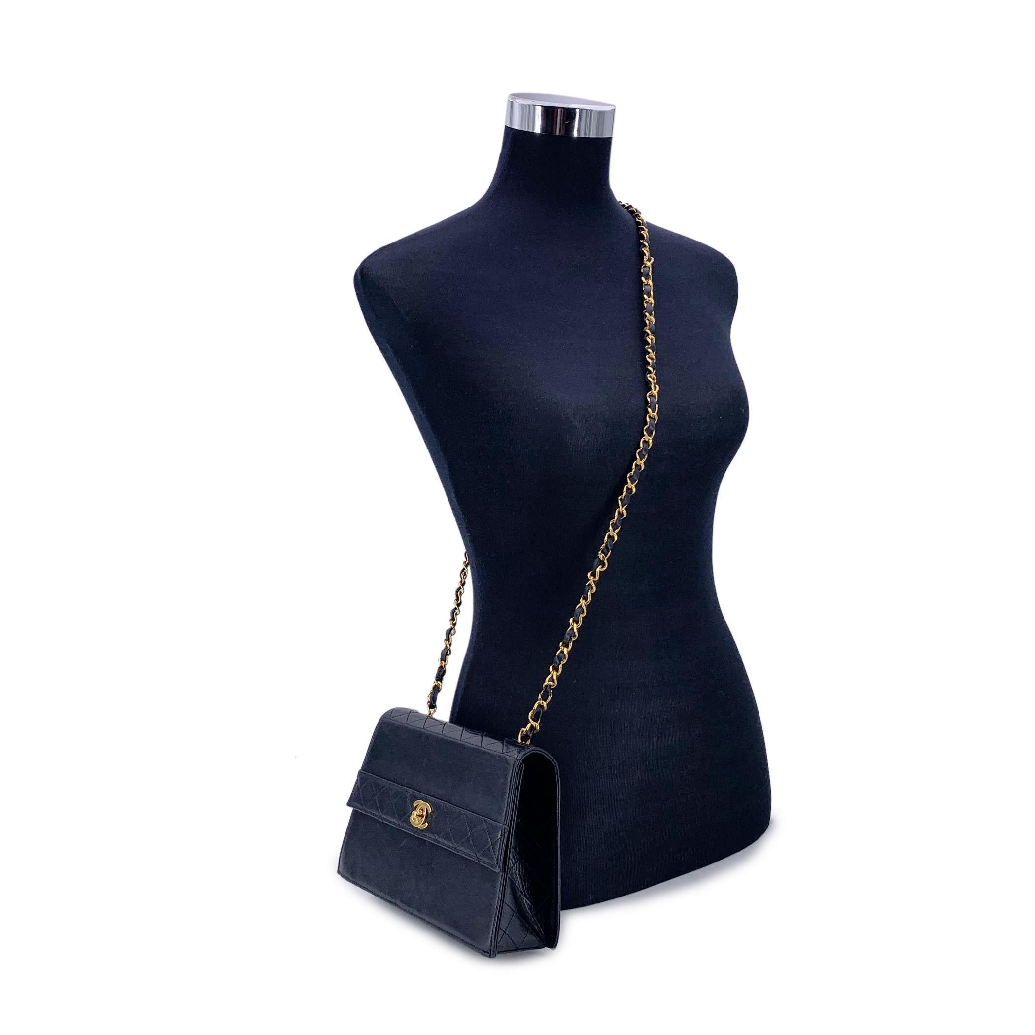 Vintage Chanel crossbody bag in black leather with Quilted leather trim. Structured design. Period/Era: 1989-1991. Flap with CC turn lock closure. Burgundy leather lining. 1 side pocket with button closure internally. Leather quilted shoulder strap.