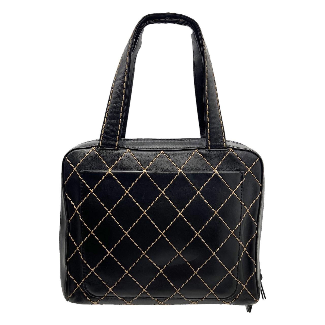 We are offering this elegant black Chanel handbag. Made in Italy sometime between 2000 & 2002, it is crafted of black leather with quilted stitch work. It has dual black leather top handles and features a dual zipper closure that opens up to an