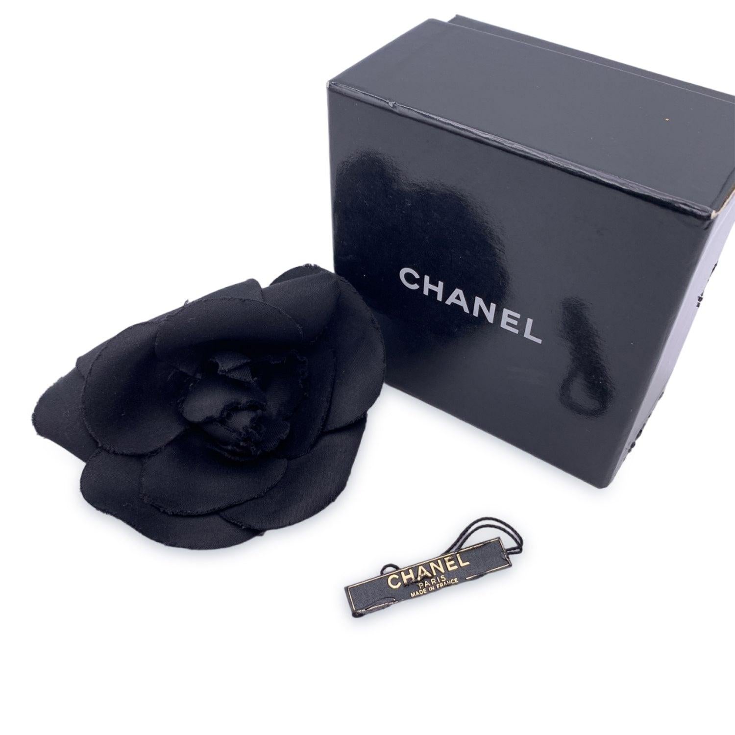 Chanel Vintage Camelia Camellia Flower Pin Brooch. Black silk petals. Safety pin closure. Measurements: diameter: 4 inches - 10.2 cm . 'CHANEL - CC - Made in France' oval tab on the back Condition B - VERY GOOD Gently used. Some glue residue on the