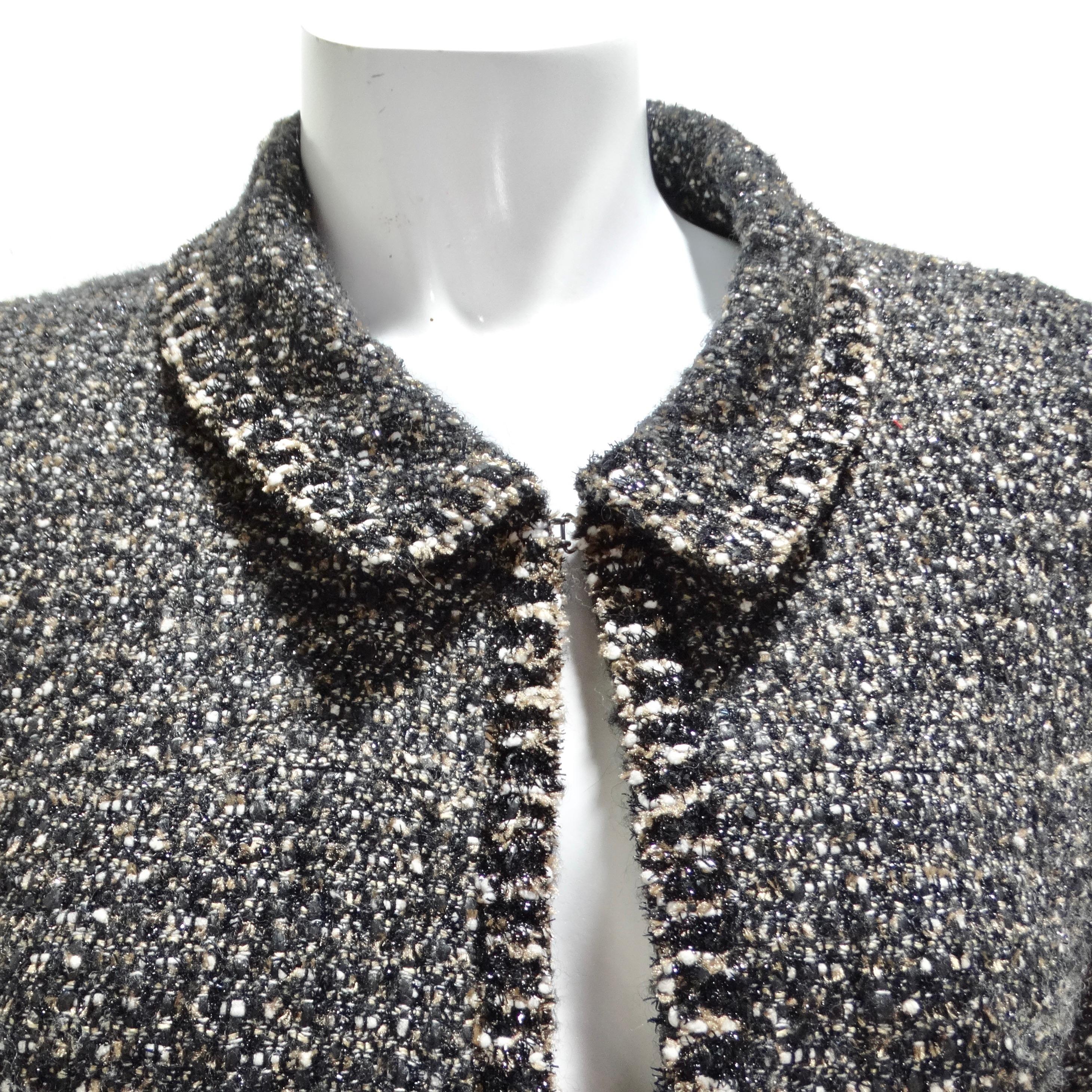 The Chanel Vintage Black Tweed Blazer is a classic and sophisticated piece that encapsulates the timeless elegance for which Chanel is celebrated. This vintage blazer, crafted from black and metallic tweed, is designed with a pointed collar and four