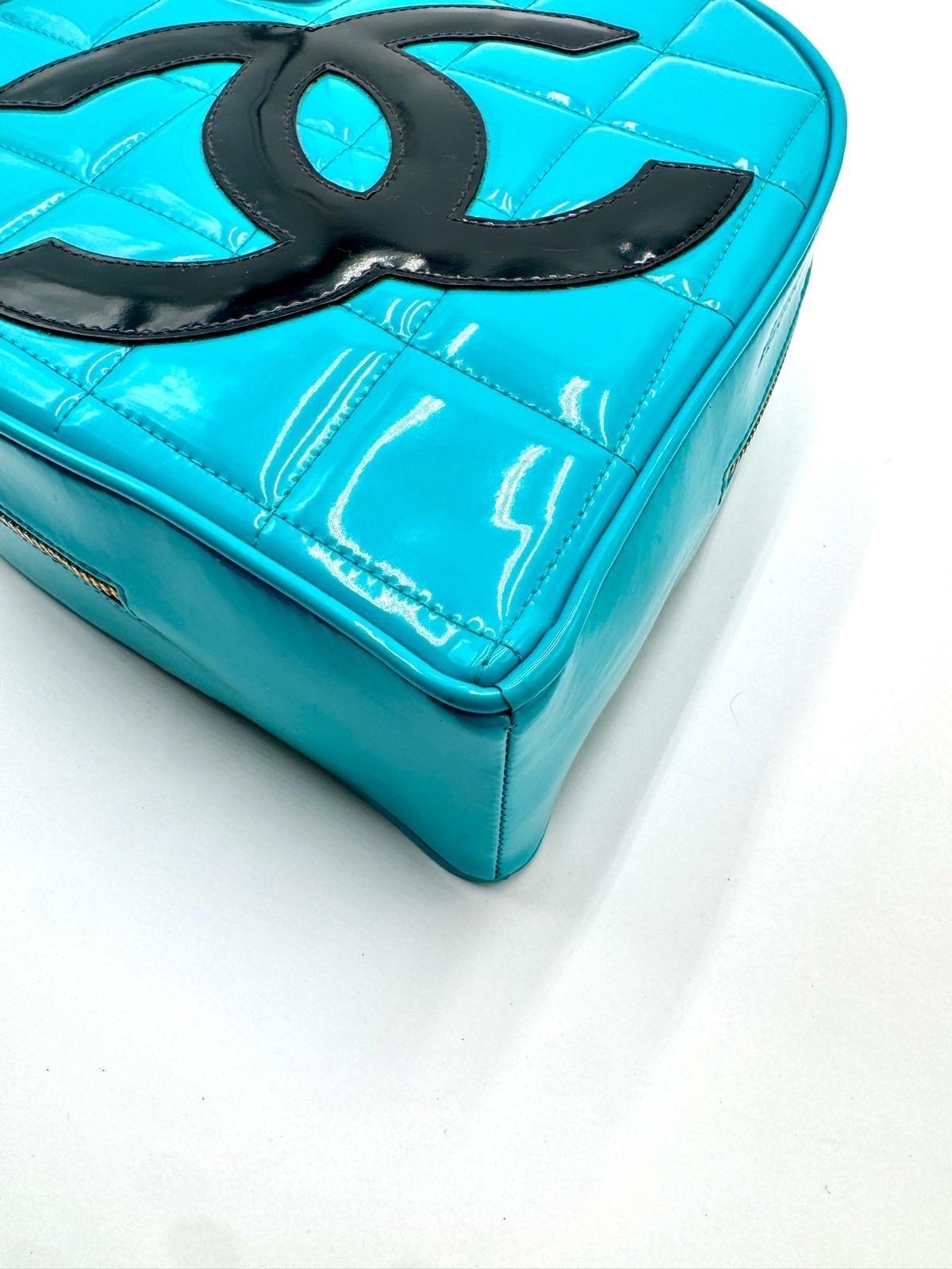 This is the iconic Chanel heart vanity bag from the 1995 Spring collection, often referred to as part of the “Barbie” line. Crafted in vibrant blue patent leather with a bold black oversized CC logo, this rare piece features diamond quilting and a
