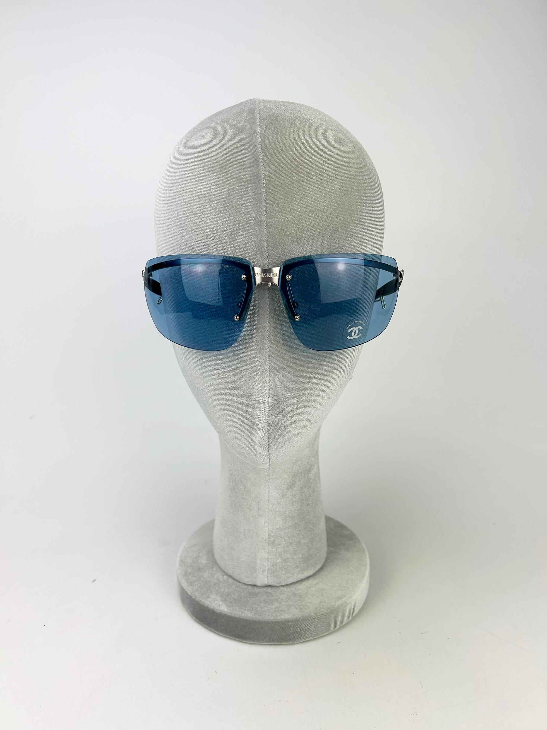 Chanel Vintage Blue Lens Matte Silver Sunglasses c2000s in excellent condition. Rectangle Blue lenses with matte silver bridge, arm and hardware. Black rubber arm ends help keep these glasses from slipping off the ears/face while worn. Chanel