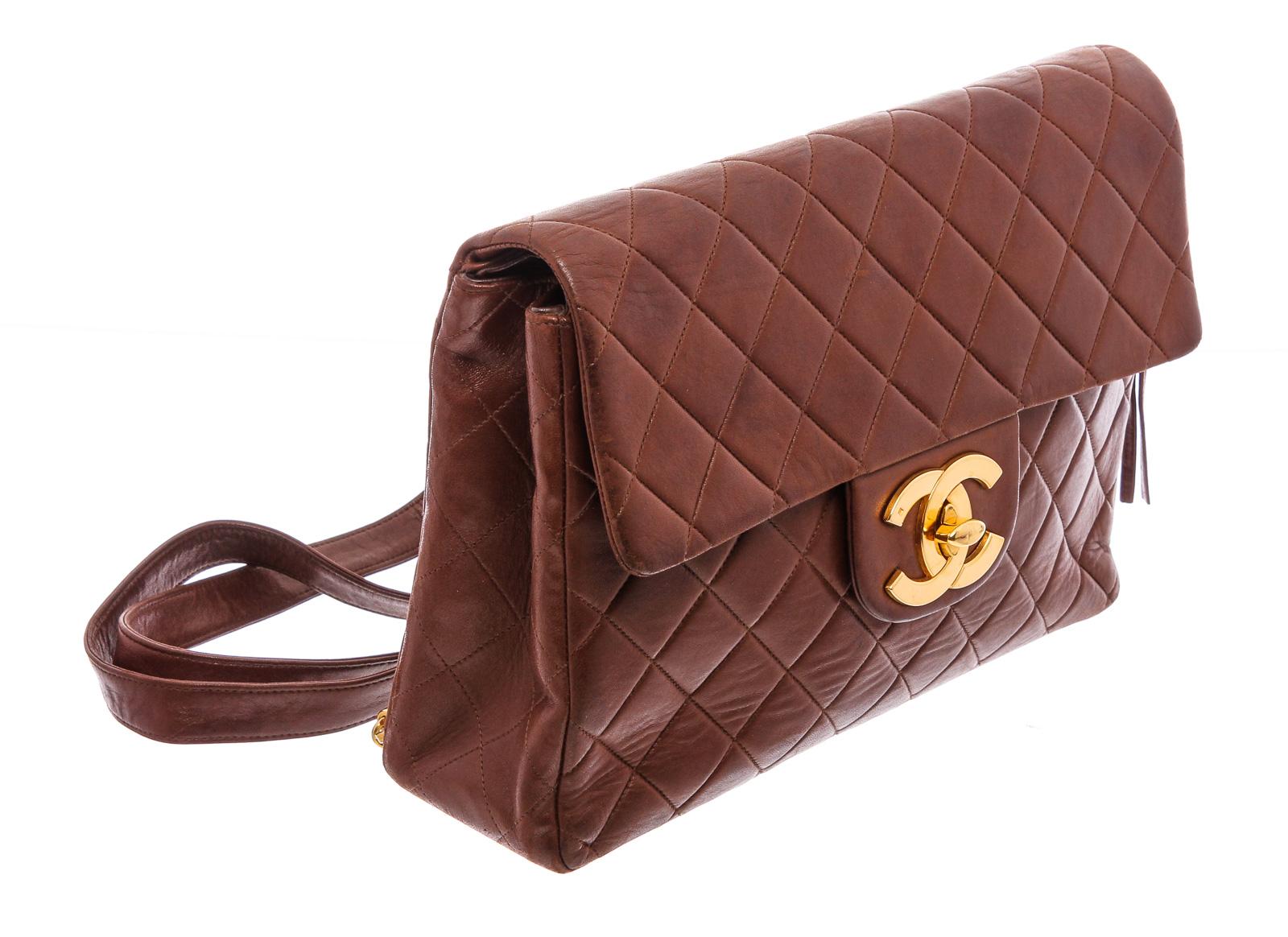 Brown quilted leather vintage Chanel Classic Flap backpack with gold-tone hardware, dual flat shoulder straps with chain-link accents, single patch pocket at back, tonal leather lining, dual pockets at interior wall; one with zip closure and zip