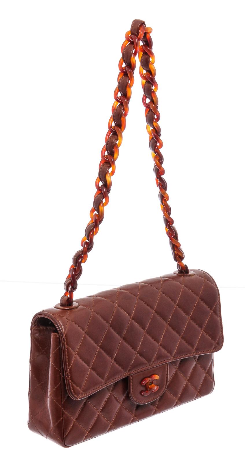Brown quilted lambskin vintage Chanel Small Flap Bag with brown tortoise shell resin chain-link and leather shoulder strap, exterior patch pocket, tonal leather lining, dual interior pockets; one with zip closure and interlocking CC turn-lock