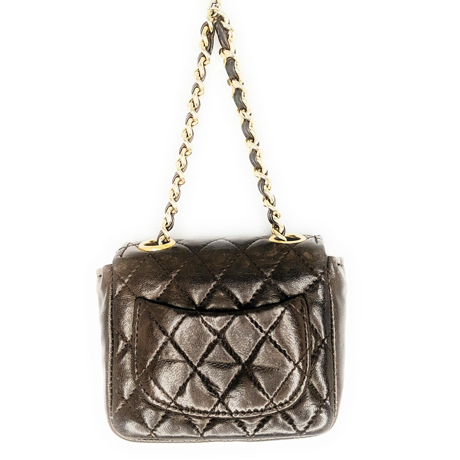 Brown quilted lambskin vintage Chanel micro belt bag with gold-tone hardware, single chain-link and leather waist strap featuring CC charm, single patch pocket at back, carmel lambskin interior and snap closure at front flap featuring CC logo