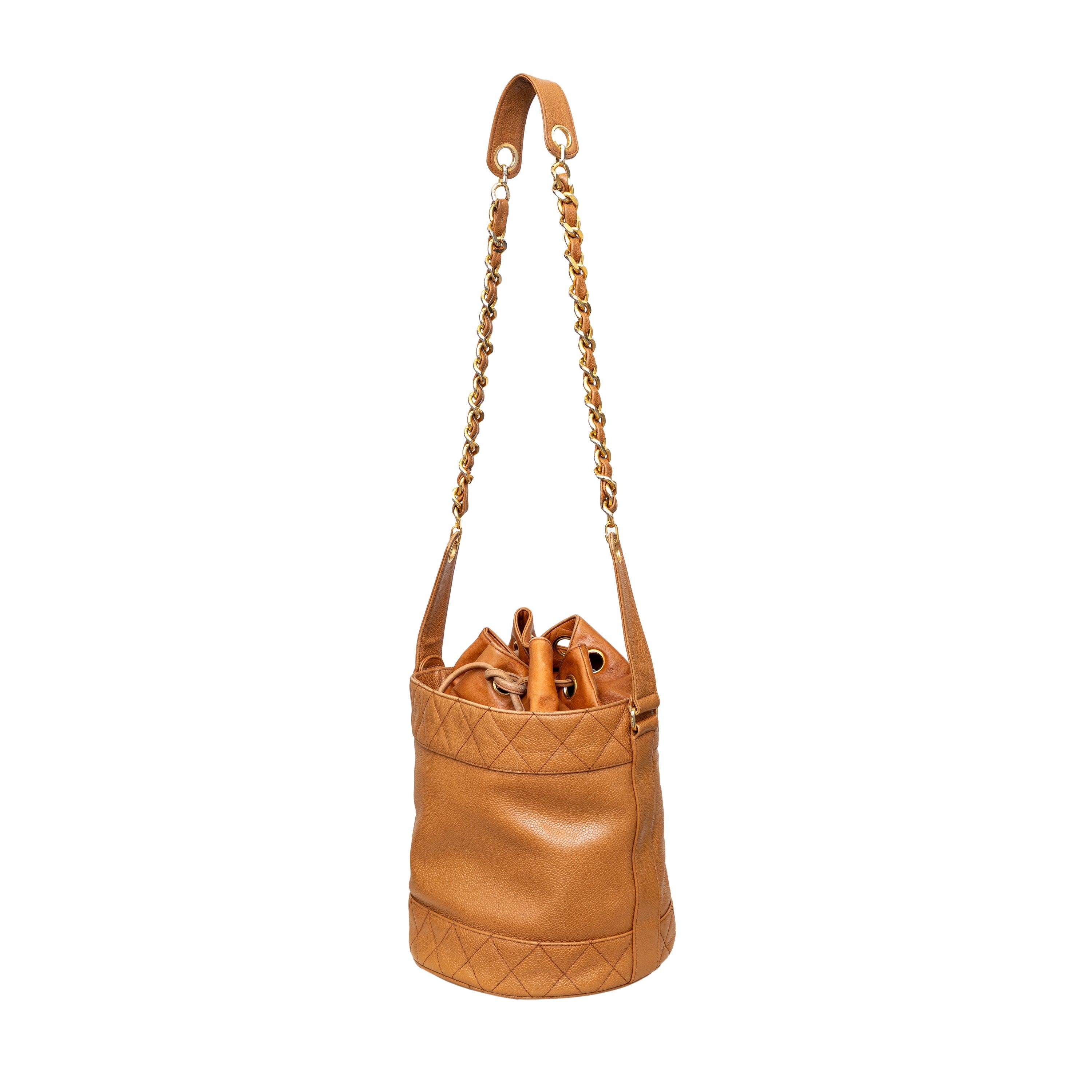 The classic and iconic Chanel bucket bag from the 90s boasts a sleek light brown leather design with diamond quilted trimming and gold-tone hardware. A convenient chain and leather strap and drawstring closure make it the perfect everyday bag. Plus,