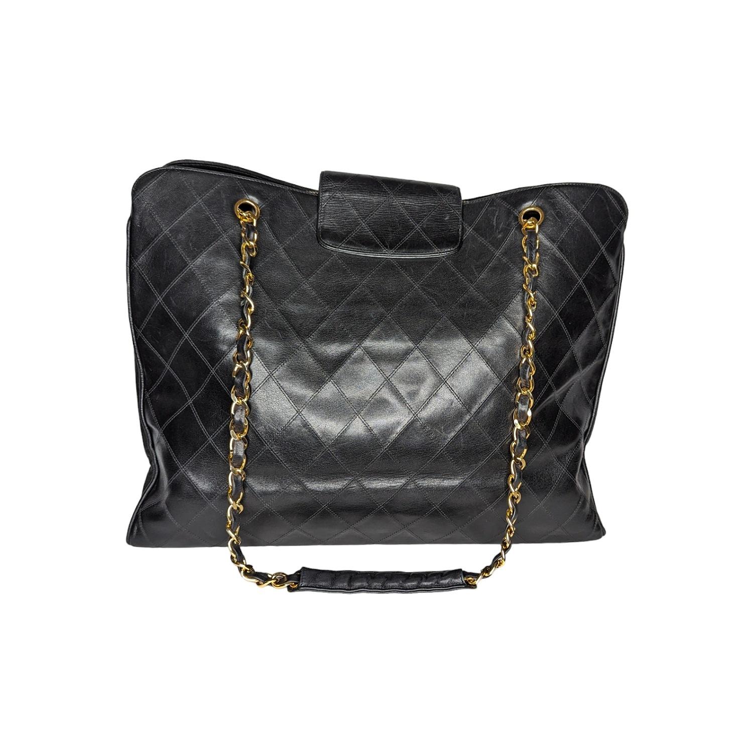 This chic vintage travel tote is crafted of luxuriously smooth diamond-stitched calfskin leather in black. The bag features leather-threaded gold-tone chain-link shoulder straps with shoulder pads and a cross-over strap with a matching gold classic