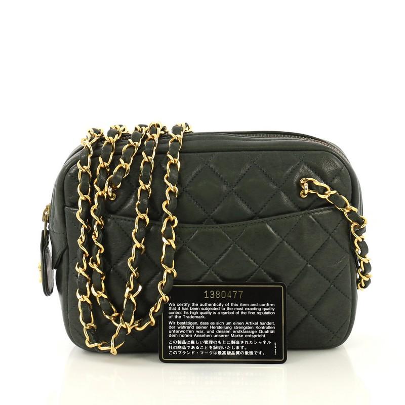 This Chanel Vintage Camera Bag Quilted Leather Medium, crafted from green quilted leather, features woven-in leather chain strap and gold-tone hardware. Its zip closure opens to a black leather interior with zip and slip pockets. Hologram sticker