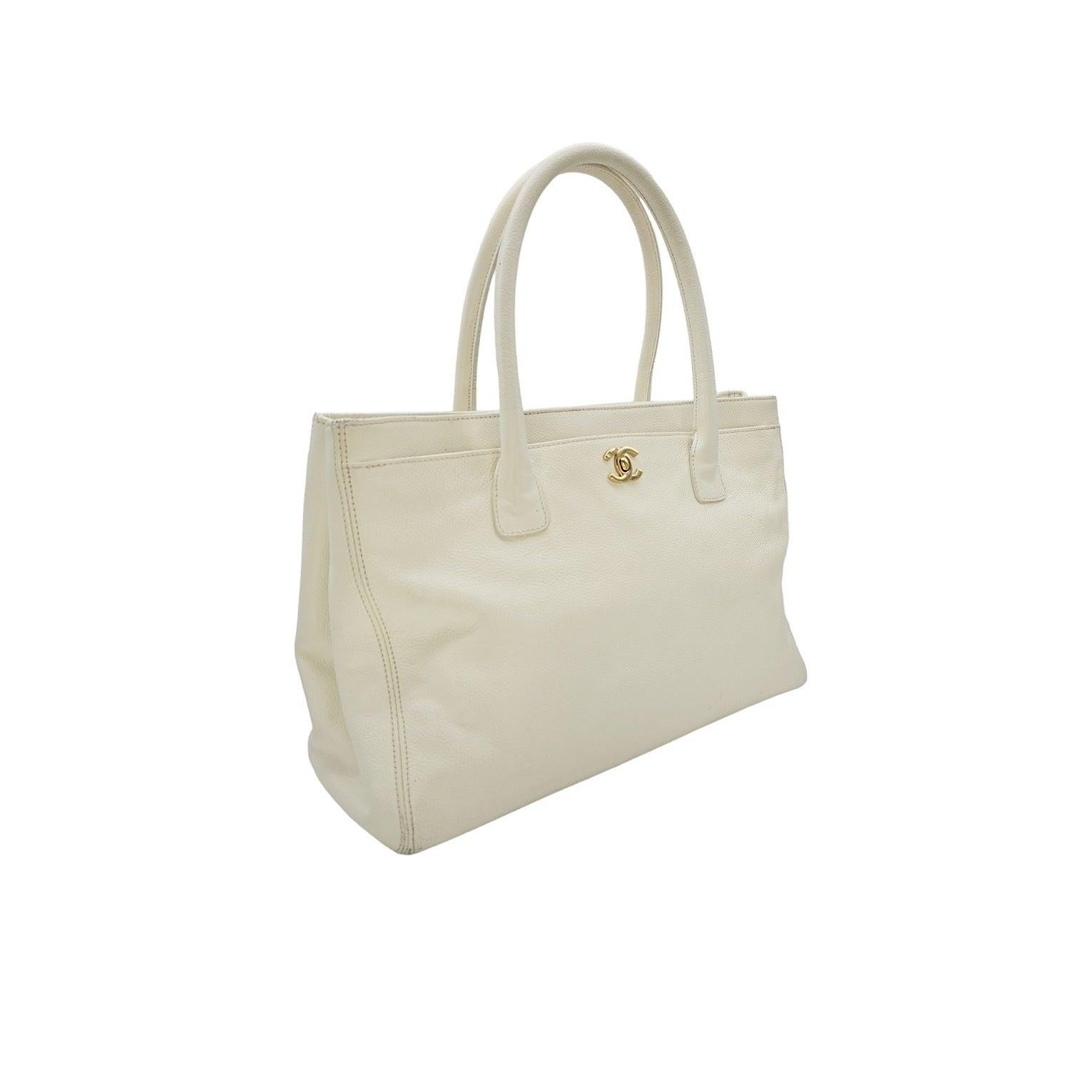 This Chanel Vintage Executive Tote is a sophisticated piece from the 2004-2005 Collection. Crafted from grained calfskin leather, it features dual rolled handles, multiple pockets, and a secure CC turn-lock closure. The spacious interior offers