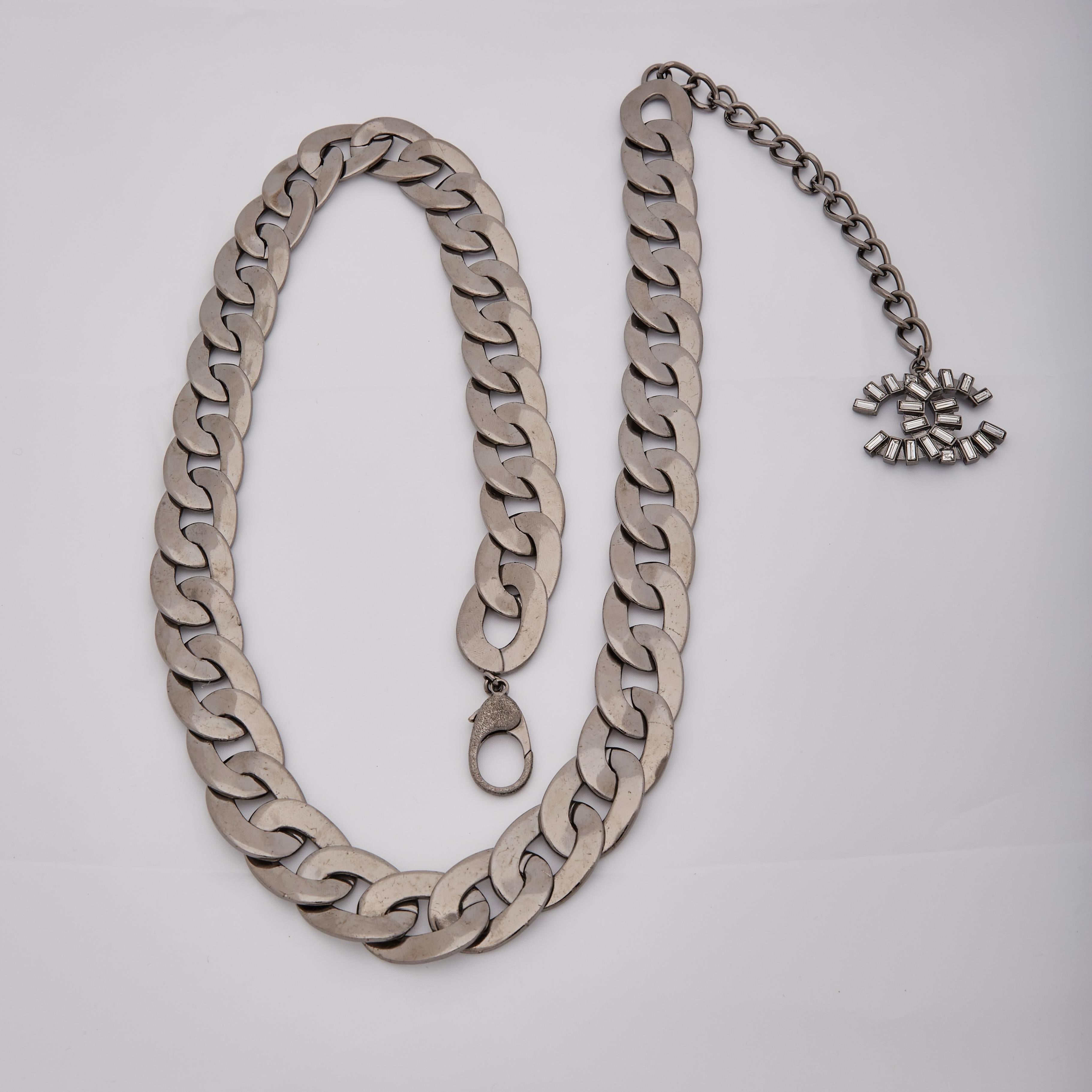 Color: Ruthenium (gunmetal) hardware
Material: Mirrored metal and baguette crystals
Marks: 06 [logo] A
Year: 2006
Clasp style: lobster clasp closure
Made in France

Measurements~
Belt Length  40”
Width 1”

Very good condition. Faint hairline