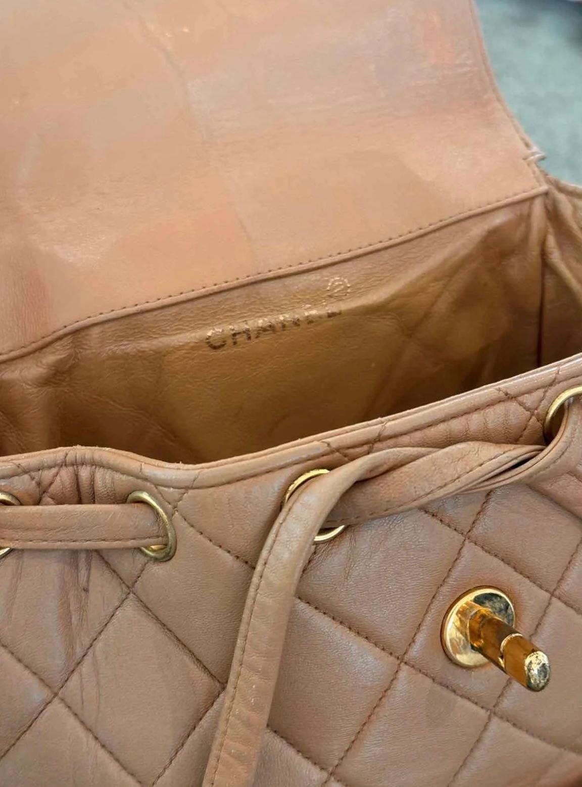 Color: Beige
Material: Lambskin leather
Condition: Fair. Discoloration, marks, stains throughout.
Made in Italy

Measurements~
Height 9”
Length 4”
Depth 9”
