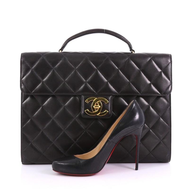 This Chanel Vintage CC Briefcase Quilted Lambskin Large, crafted from black quilted lambskin, features a leather top handle, front flap and gold-tone hardware. Its CC turn-lock closure opens to a black leather interior with zip and slip pockets.