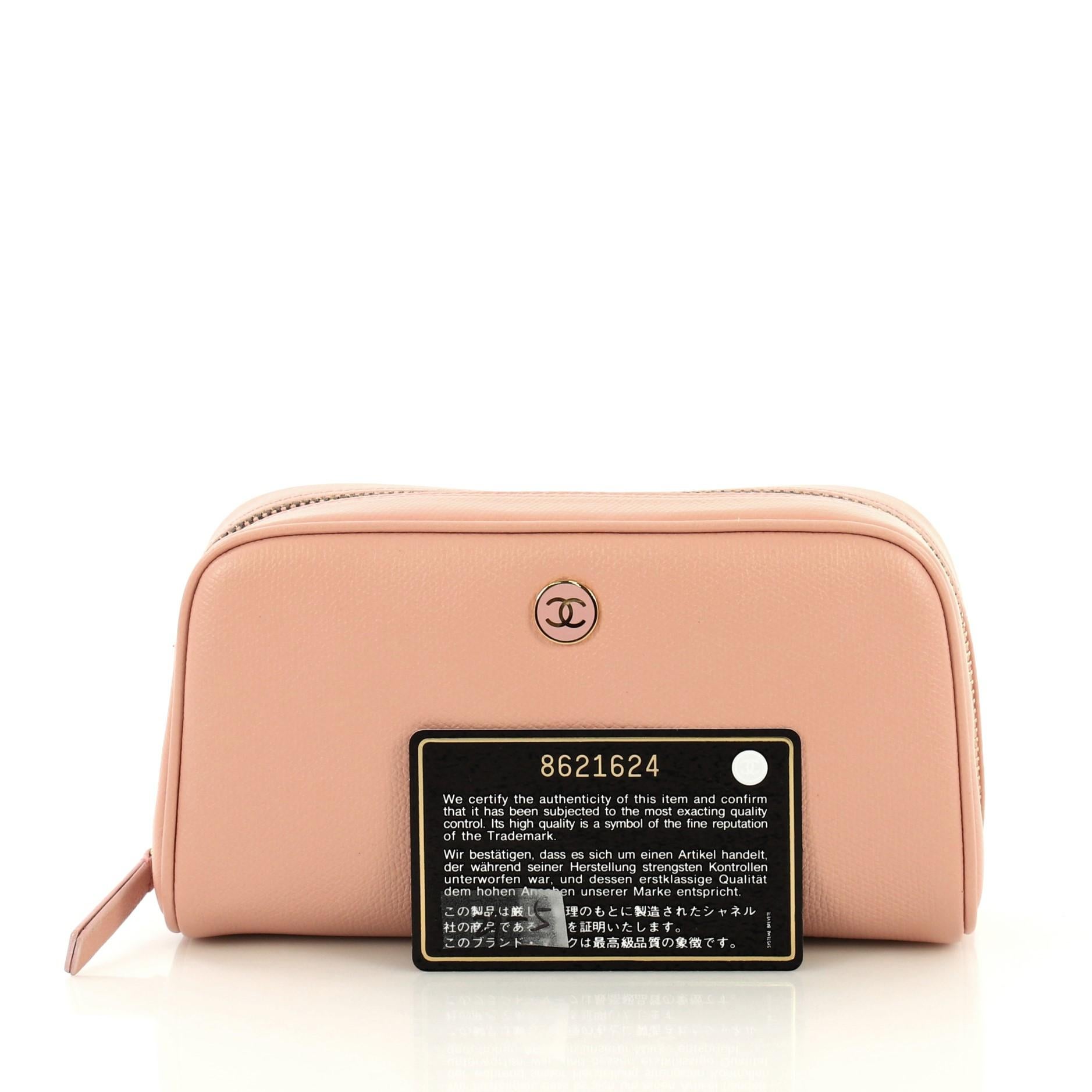 This Chanel Vintage CC Button Cosmetic Pouch Leather Medium, crafted from pink leather, features gold-tone hardware. Its zip closure opens to a neutral fabric interior. Authenticity code reads: 8621624. 

Condition: Great. Slight creasing on