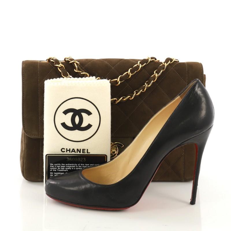 This Chanel Vintage CC Chain Flap Bag Quilted Suede Medium, crafted from olive green quilted suede, features woven-in suede chain link strap, and gold-tone hardware. Its CC turn-lock closure opens to a brown leather interior with zip and slip