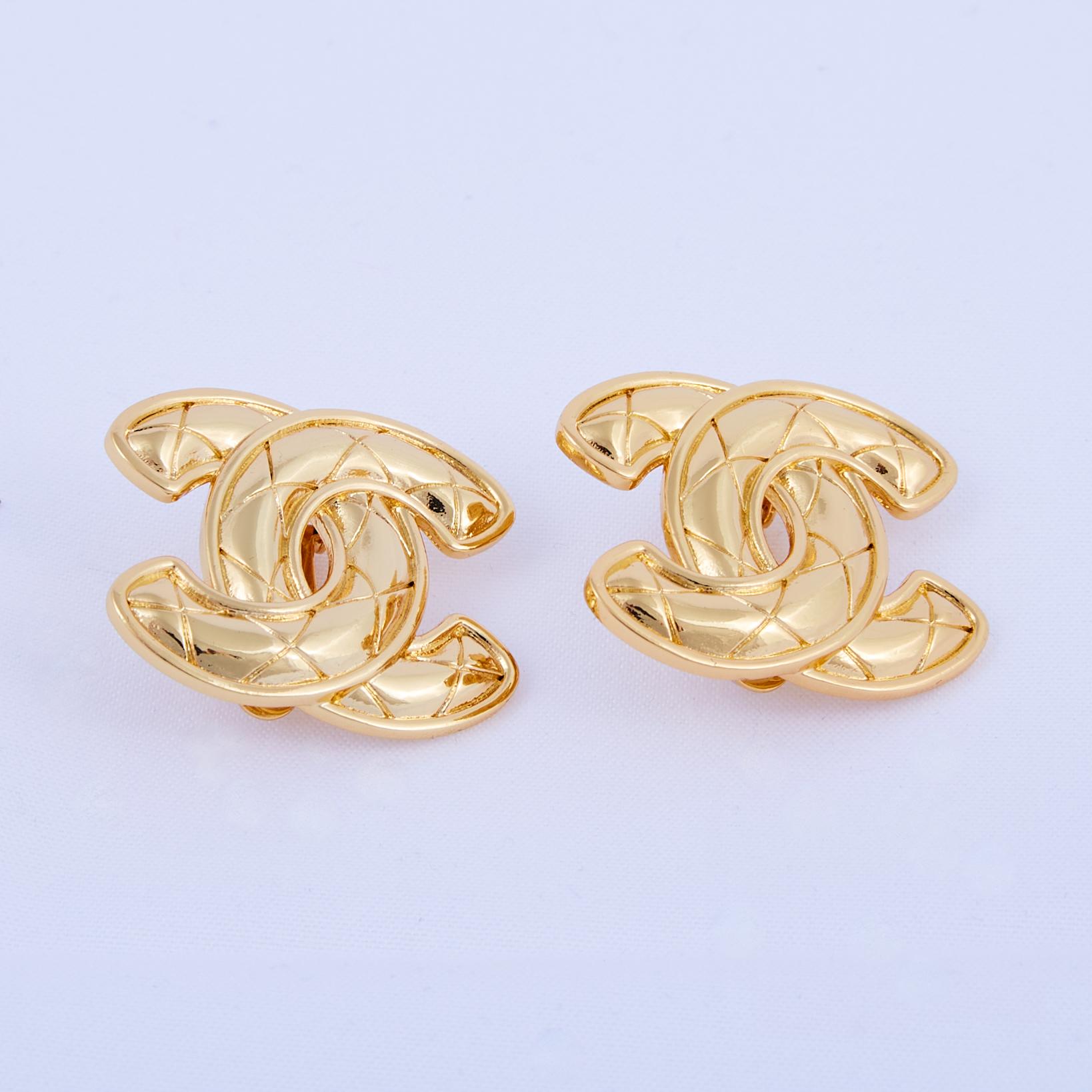Designed by Coco Chanel in 1925, the interlocking CC logo became Chanel's signature. With a gold-plated brass construction finished with diamond quilting, these clip-on earrings display the iconic motif for an instantly recognizable look. Circa