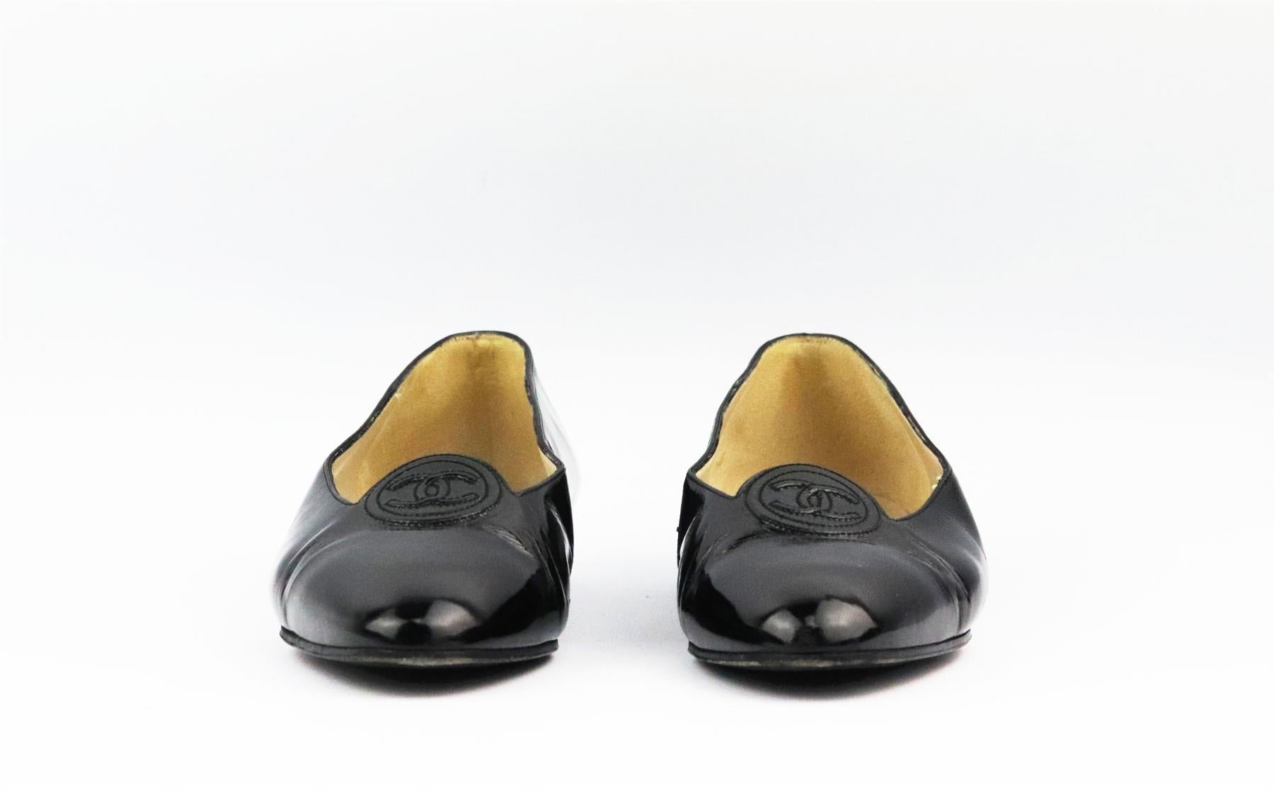These vintage ballerina flats by Chanel are always stand out pieces, even designs as classic as these flats, made in Italy from black patent leather and that are balanced out with an almond toe and CC embroidered detail. Sole measures approximately