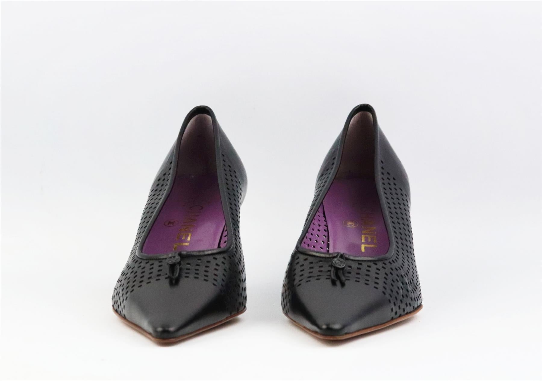 These vintage pumps by Chanel have been made in Italy from black perforated leather, they're set on a small structured stiletto heel that's balanced with a pointed toe and drawstring CC detail on the front. Heel measures approximately 50 mm/ 2