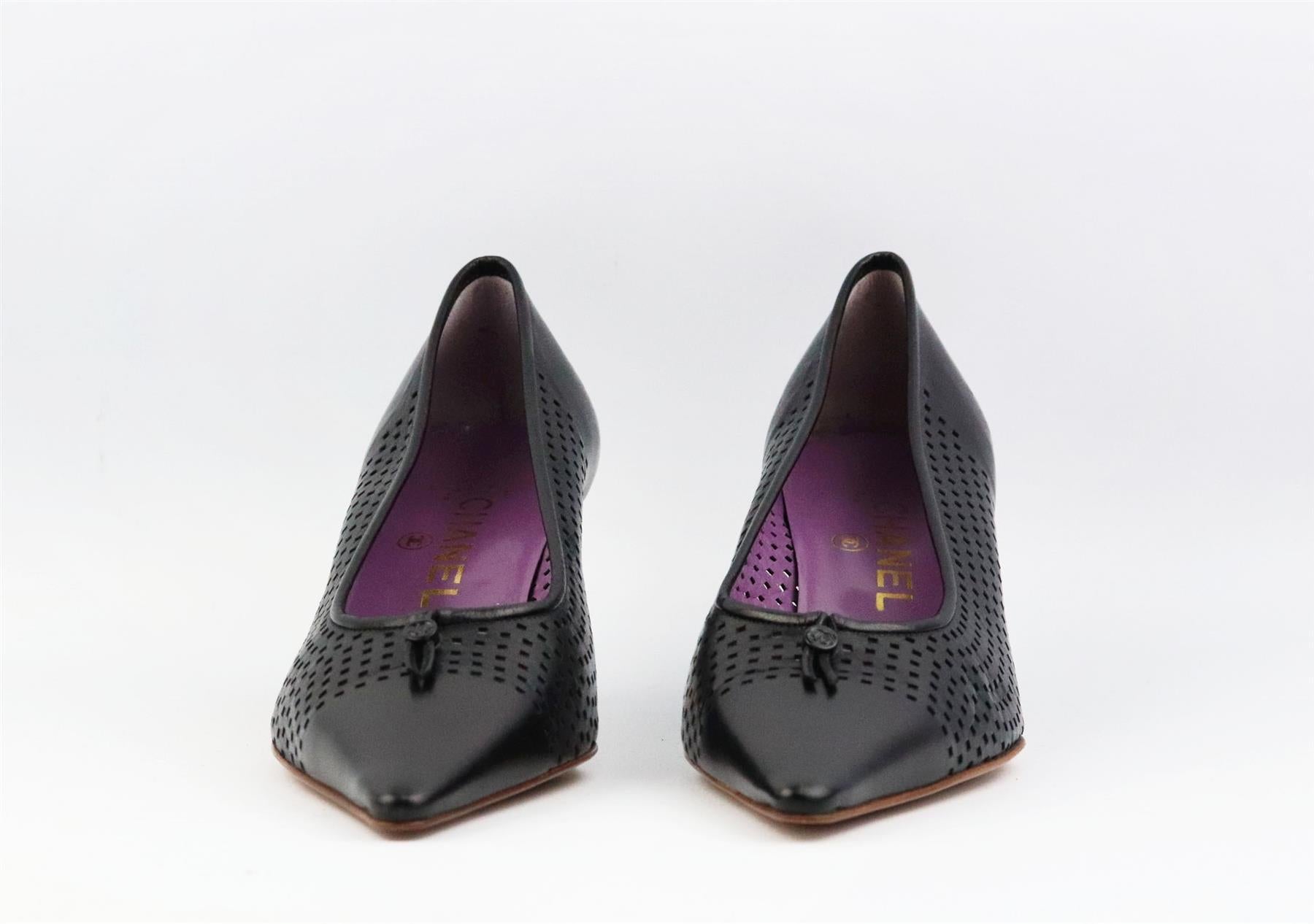 Diese Vintage-Pumps von Chanel wurden in Italien aus schwarzem, perforiertem Leder gefertigt. Sie haben einen kleinen, strukturierten Stiletto-Absatz, der durch eine spitze Spitze und ein CC-Detail mit Kordelzug auf der Vorderseite ausgeglichen
