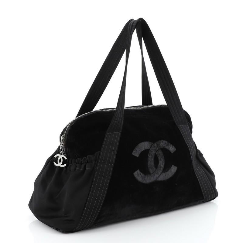 This Chanel Vintage CC Tote Velvet Medium, crafted in black velvet, features dual flat handles, exterior side pockets, and silver-tone hardware. It opens to a black fabric interior. Hologram sticker reads: 9523798.

Estimated Retail Price: