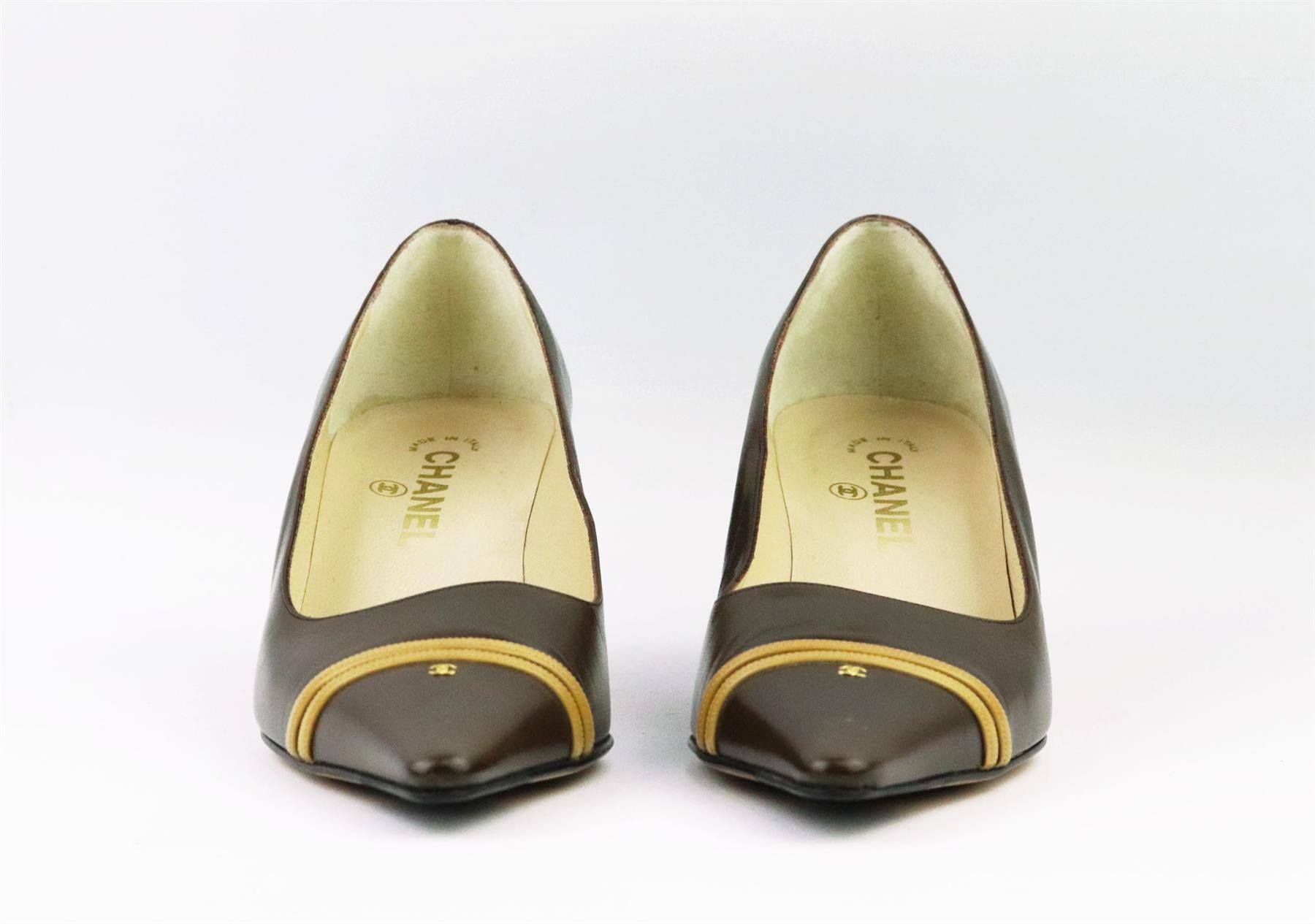 These vintage pumps by Chanel have been made in Italy from beige and brown leather, they're set on a small structured metal stiletto heel that's balanced with a pointed toe and striped CC detail on the front. Heel measures approximately 50 mm/ 2