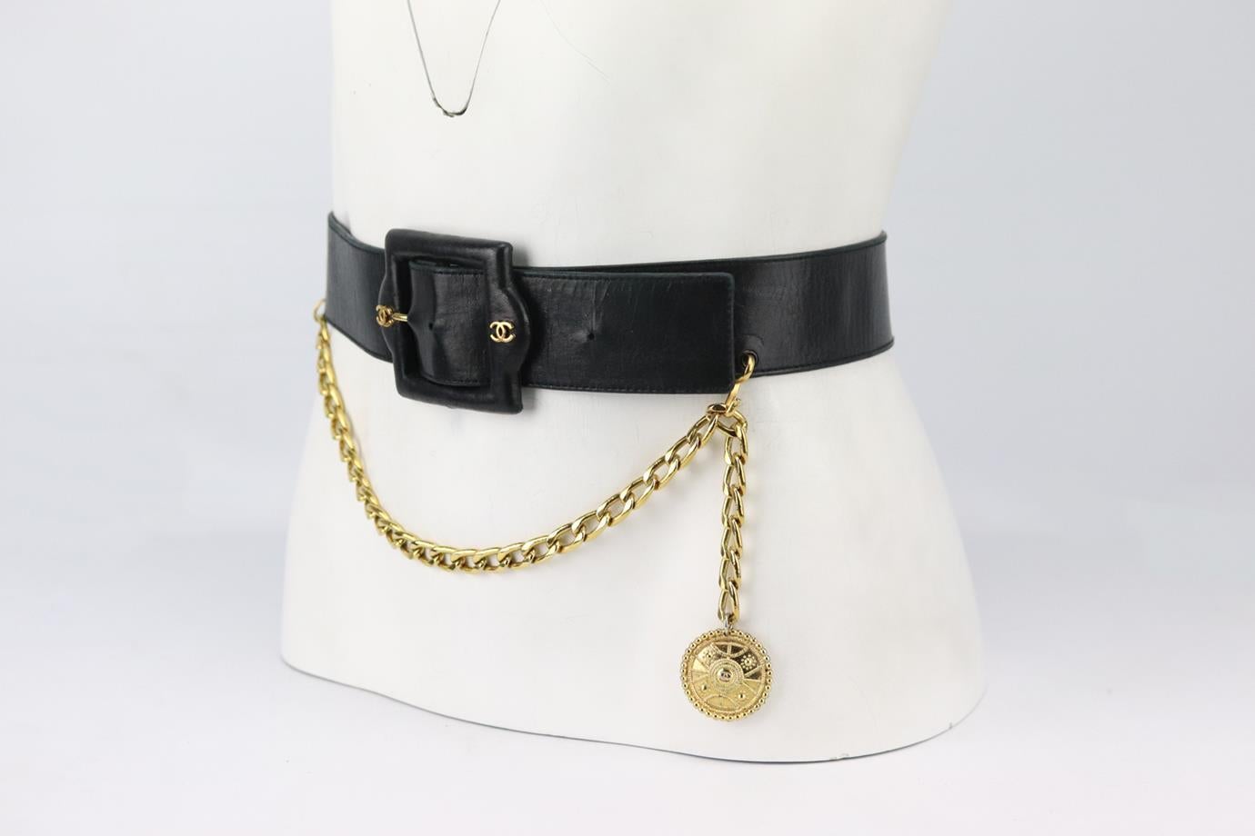 Chanel Vintage chain trimmed leather waist belt. Made from soft black leather with gold-tone chain and medallion detail at the front. Black. Buckle fastening at front. Size: XSmall (70 cm). Length Min: 26 in. Length Max: 30 in. Width: 1.7 in