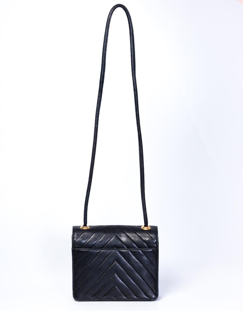 Chanel Vintage Chevron Quilted Black Leather Mini Flap Bag (circa 1989)

This vintage Mini Flap bag by Chanel is made with black chevron quilted leather. Featuring gold toned hardware, single leather shoulder strap, a back patch pocket and a flap