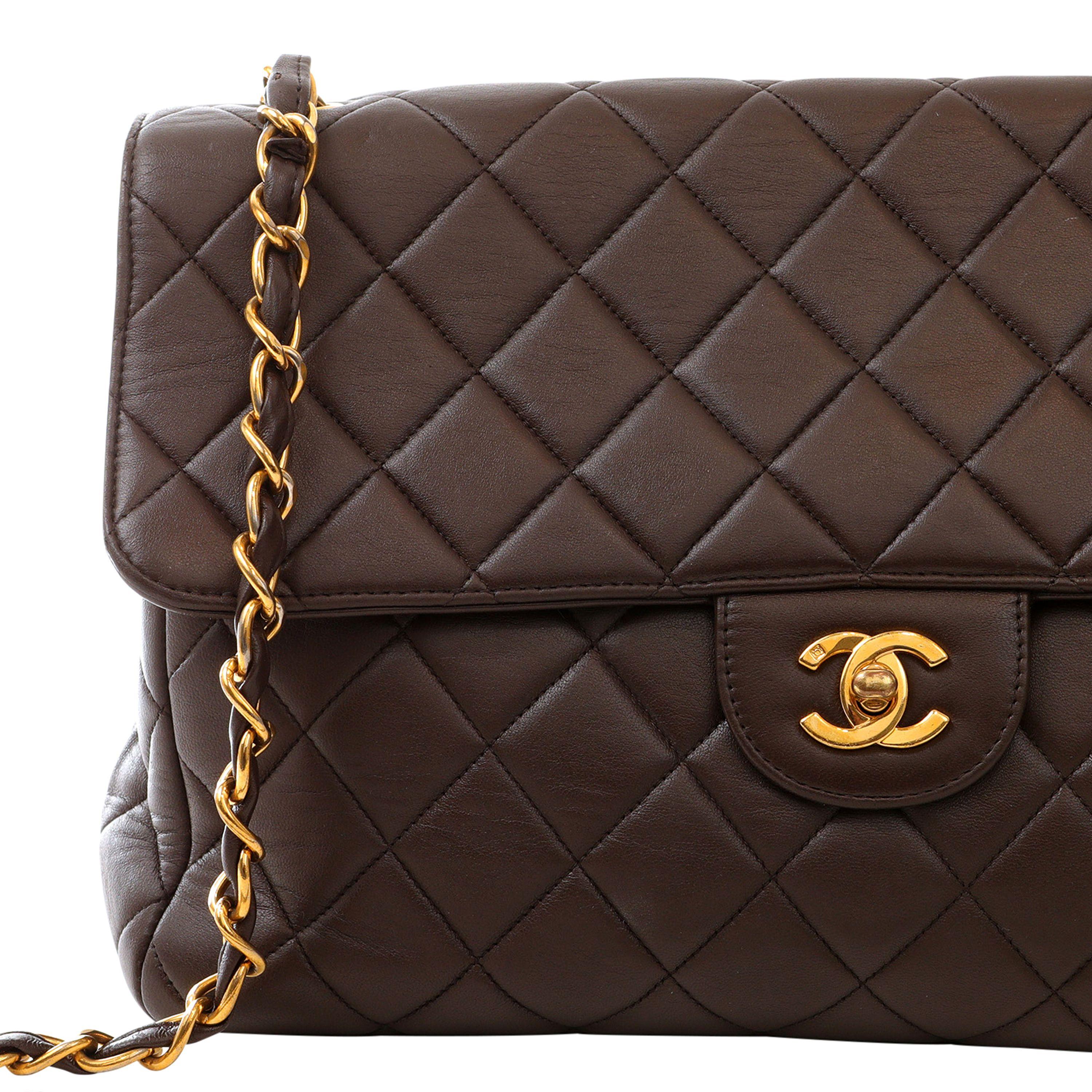 This authentic Chanel Chocolate Brown Lambskin Jumbo Classic is in excellent plus vintage condition.  Supple chocolate lambskin is quilted in signature Chanel diamond pattern.  Gold interlocking CC twist lock.  Chain strap may be carried single or