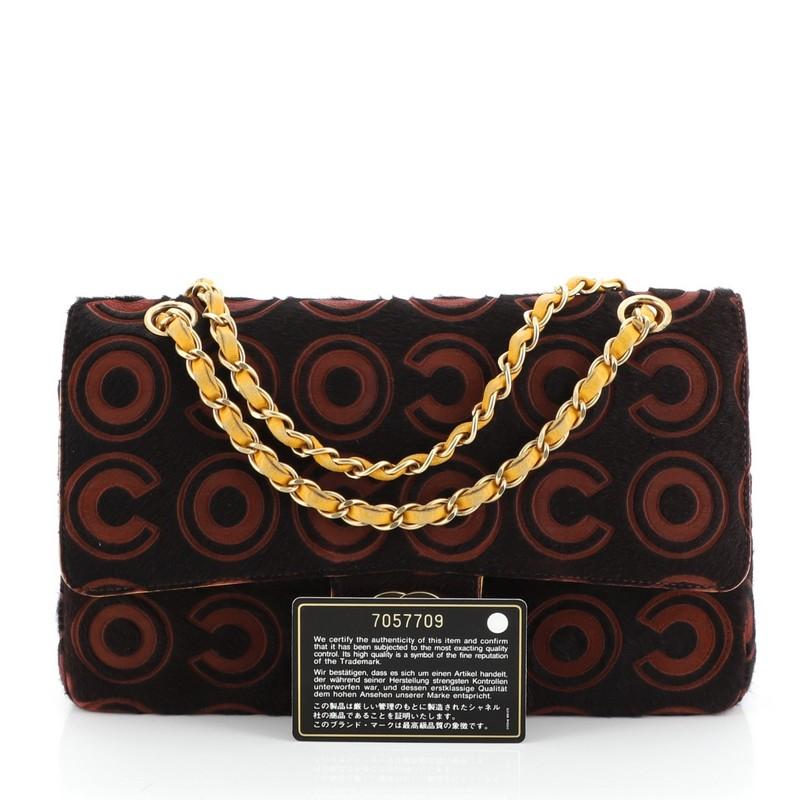 This Chanel Vintage Classic Double Flap Bag Coco Pony Hair Medium, crafted from black and red pony hair, features woven-in leather chain strap, exterior back pocket and matte gold-tone hardware. Its double flap and frontal CC turn-lock closure opens