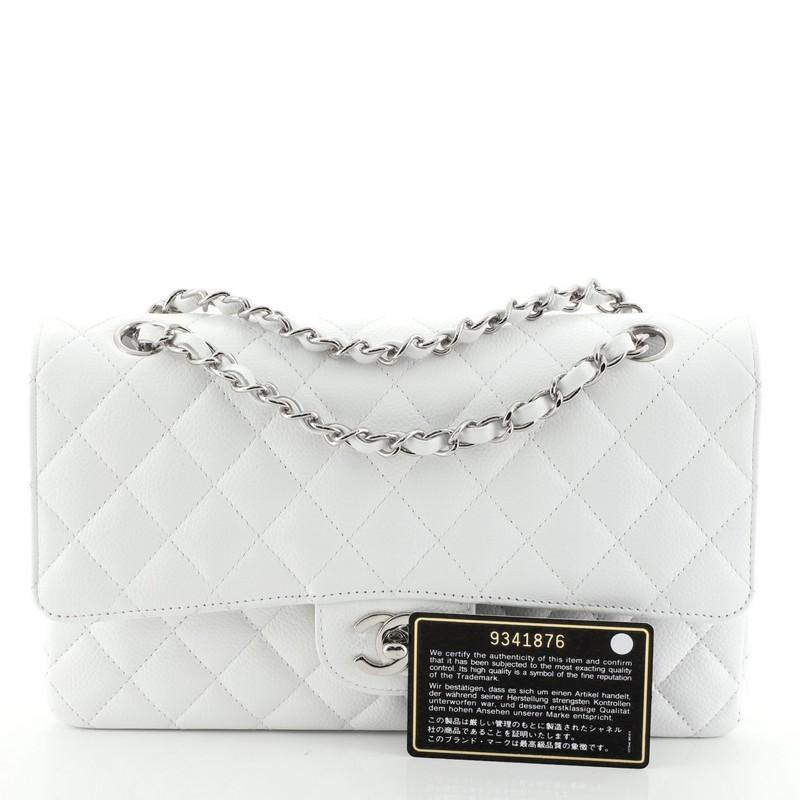 This Chanel Vintage Classic Double Flap Bag Quilted Caviar Medium, crafted from white quilted caviar leather, features woven-in leather chain strap, exterior back pocket and silver-tone hardware. Its double flap and frontal CC turn-lock closure