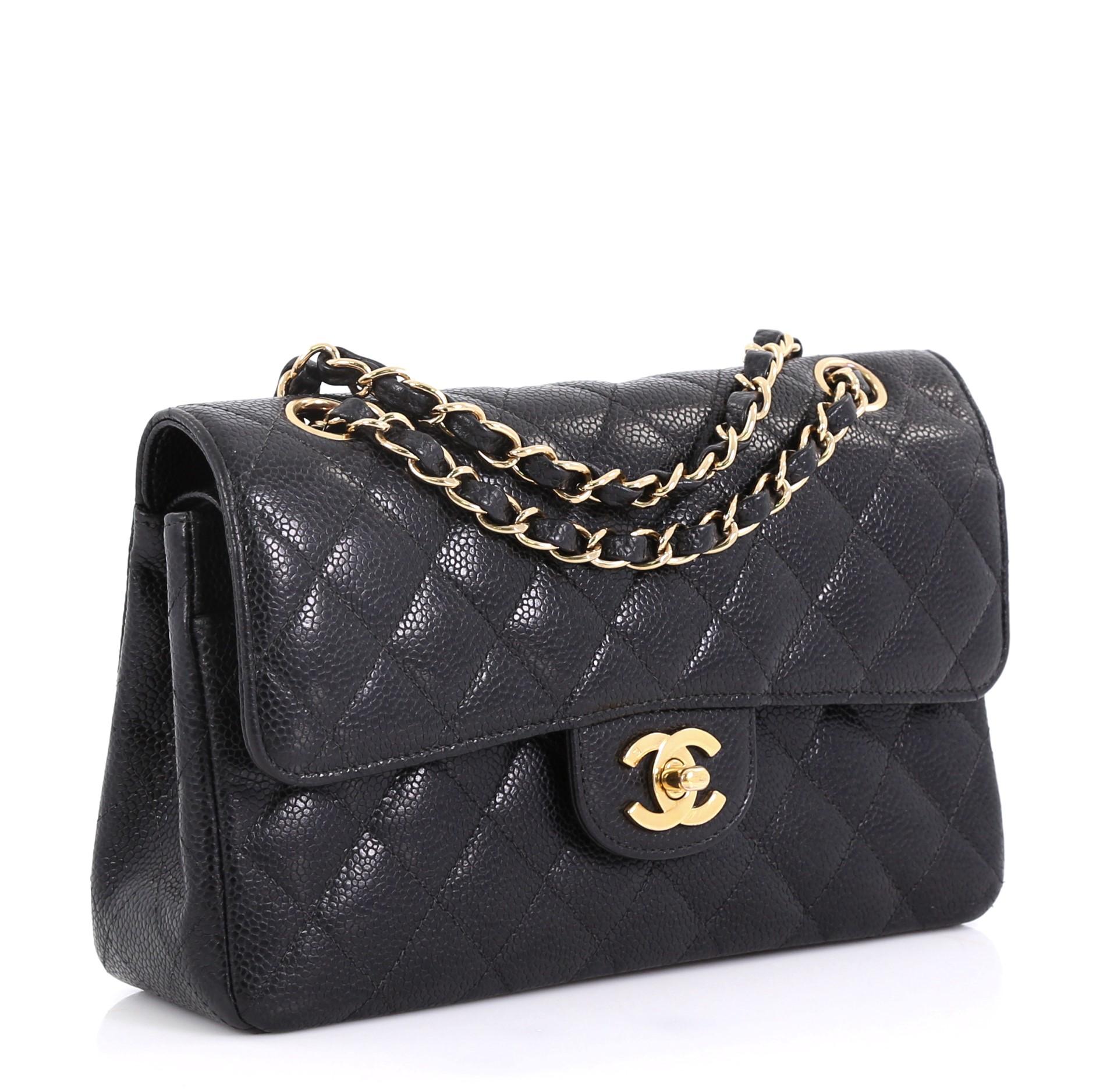 This Chanel Vintage Classic Double Flap Bag Quilted Caviar Small, crafted from black quilted caviar leather, features woven-in leather chain strap, exterior back pocket and gold-tone hardware. Its double flap and frontal CC turn-lock closure opens