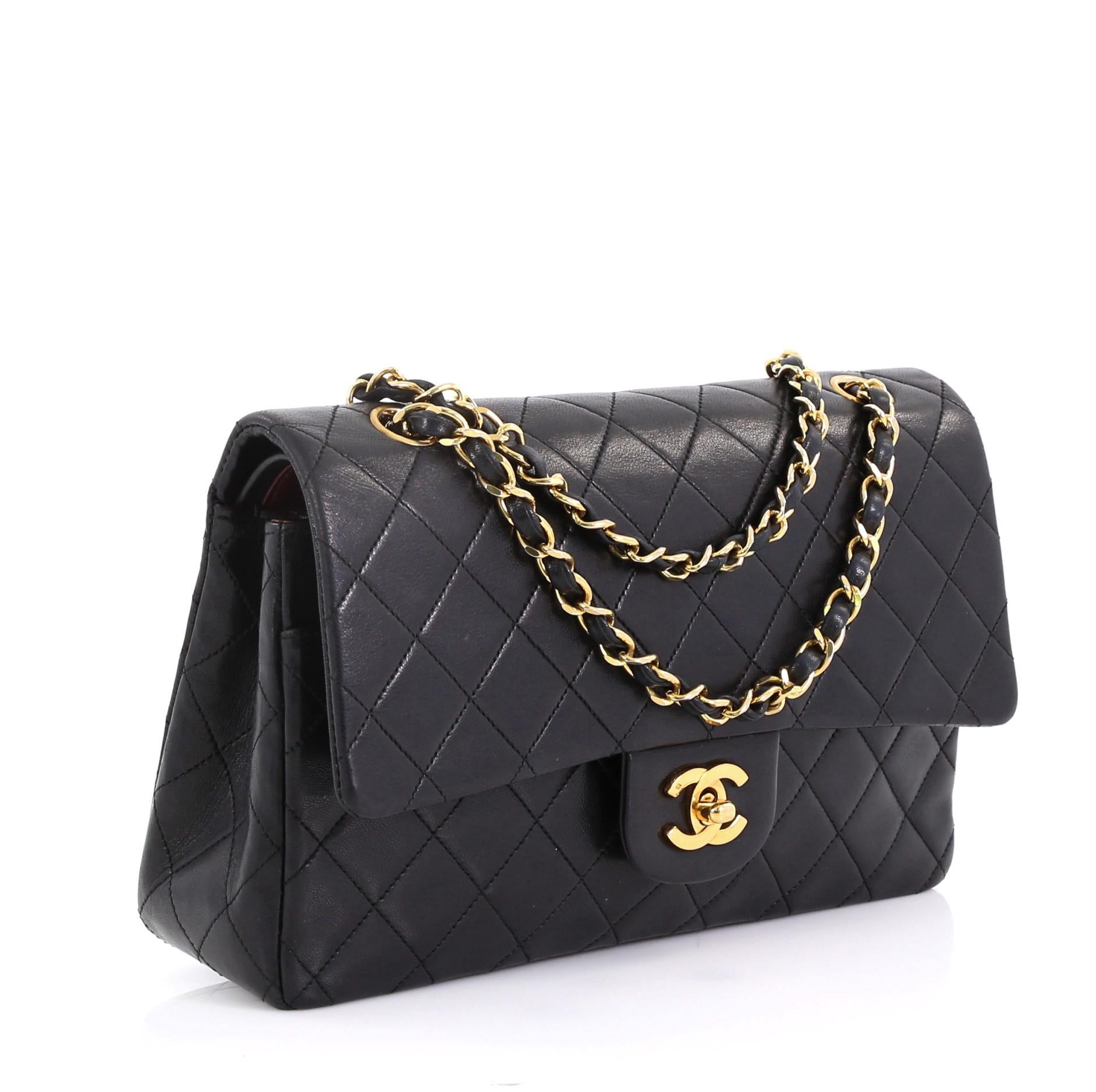 This Chanel Vintage Classic Double Flap Bag Quilted Lambskin Medium, crafted from black quilted lambskin leather, features woven-in leather chain strap, exterior back pocket and gold-tone hardware. Its double flap and frontal CC turn-lock closure