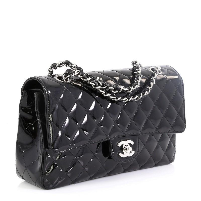 This Chanel Vintage Classic Double Flap Bag Quilted Patent Medium, crafted from black quilted patent leather, features woven-in leather chain straps, exterior back pocket, and gunmetal-tone hardware. Its double flap and frontal CC turn-lock closure