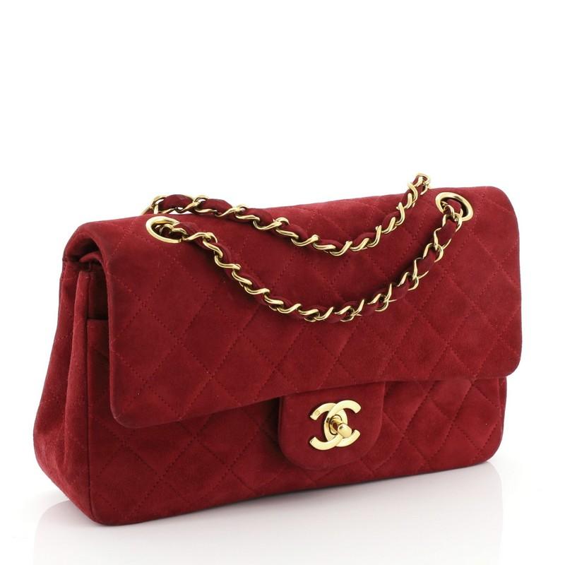 This Chanel Vintage Classic Double Flap Bag Quilted Suede Small, crafted from pink quilted suede, features woven-in suede chain strap, exterior back slip pocket and gold-tone hardware. Its frontal CC turn-lock closure opens to a red leather interior