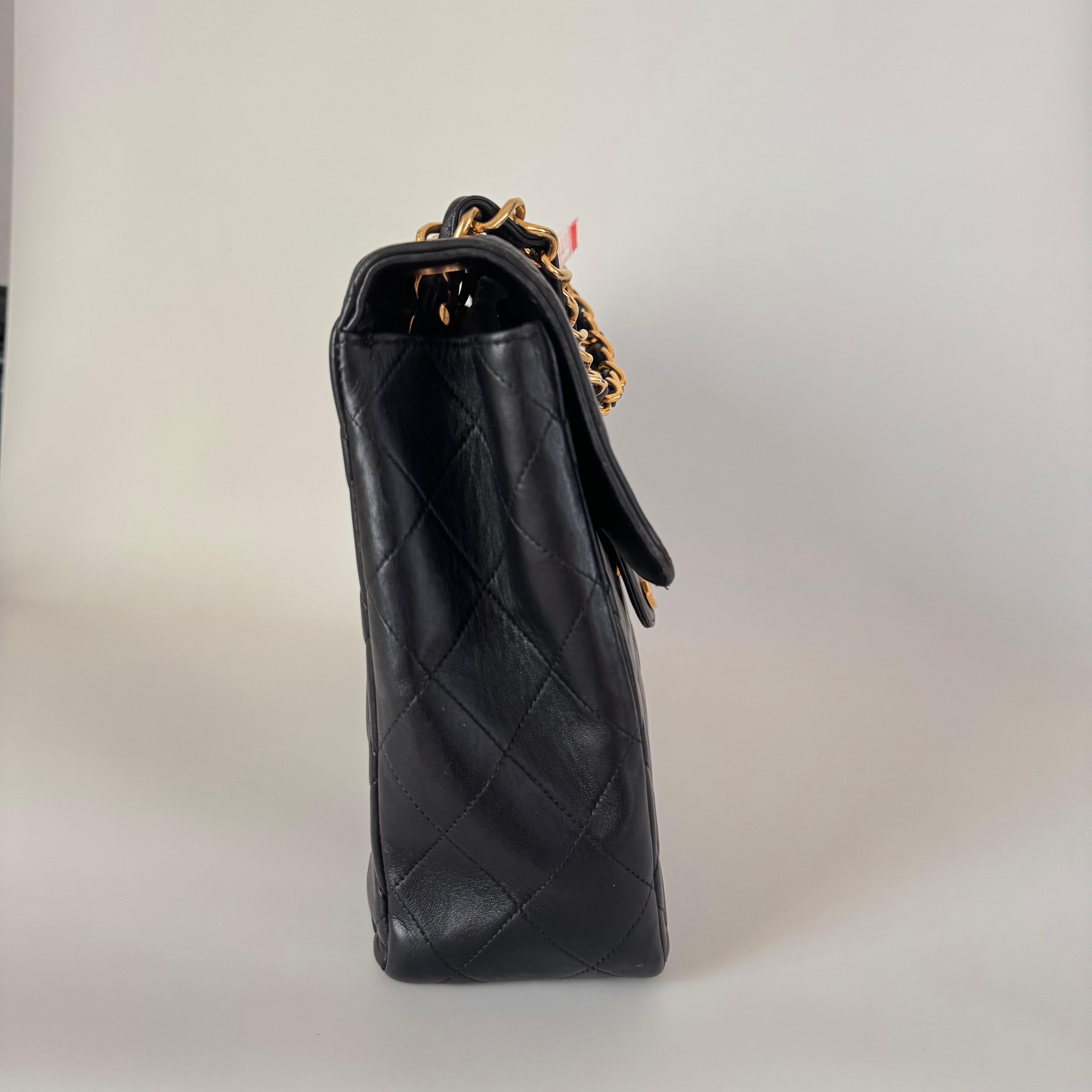 Experience timeless elegance with the Chanel Classic Flap Maxi Shoulder Bag. Crafted with luxurious lambskin leather and 24k gold plated hardware, this stunning bag exudes sophistication. The iconic big CC logo stands out, making it a statement