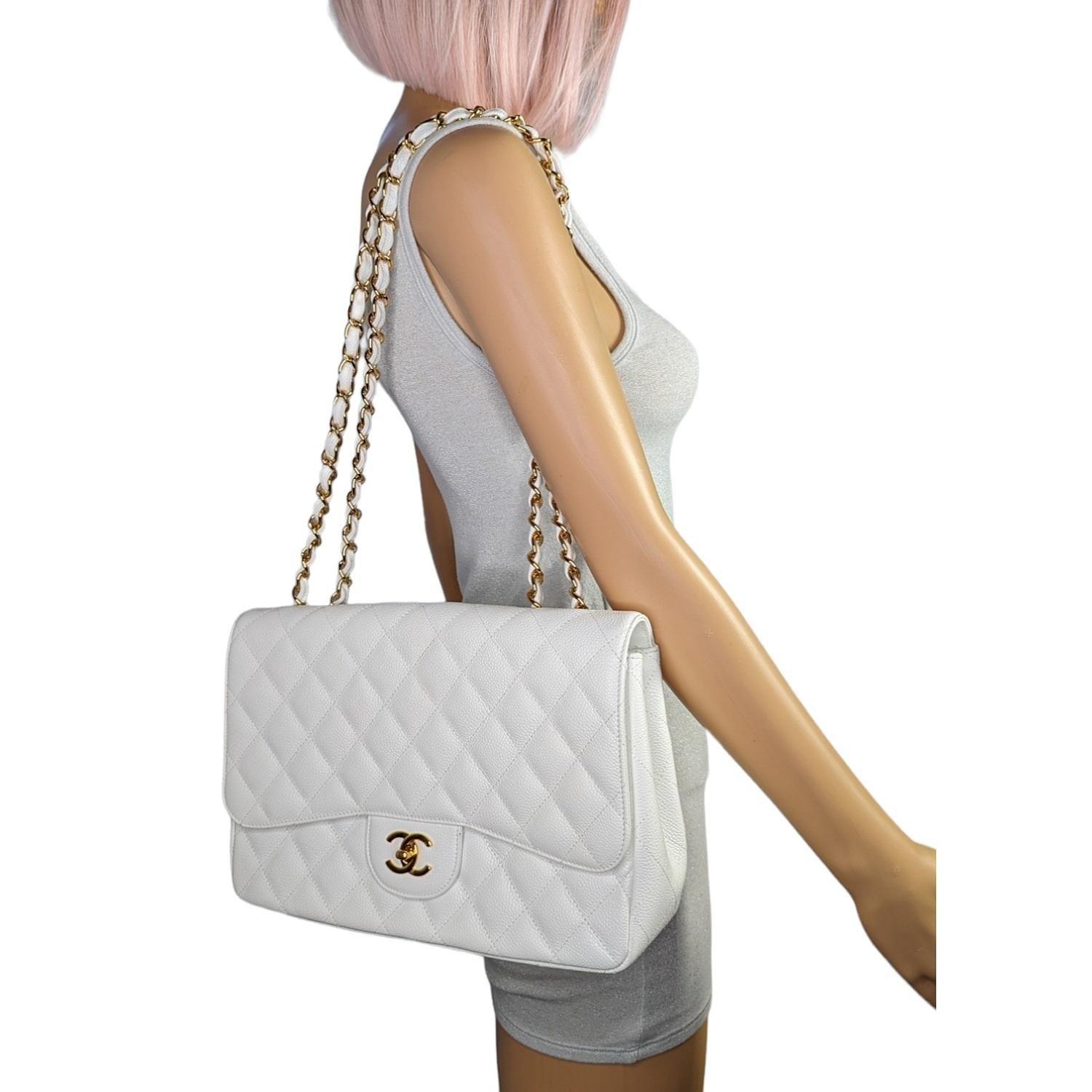 White quilted Caviar leather Chanel Classic Jumbo Single Flap Bag with polished gold-tone hardware, single convertible chain-link shoulder strap, single patch pocket at back, tonal leather lining, dual interior pockets; one with zip closure and