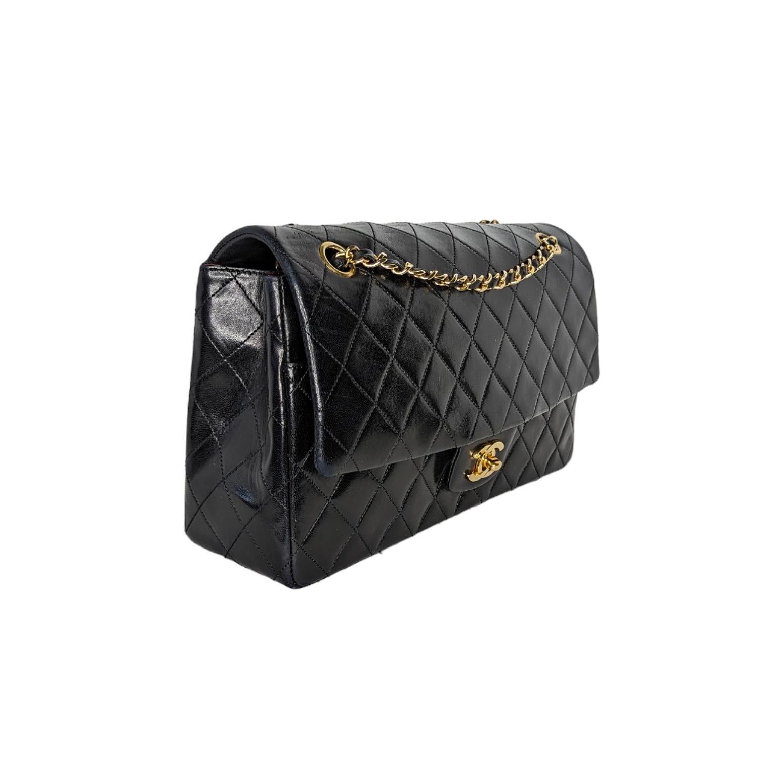 From the 1989-1991 Collection by Karl Lagerfeld; Chanel Lambskin Quilted Medium Single Flap with Wallet. This stylish vintage flap bag is finely crafted of diamond quilted lambskin leather in black. The bag features a gold chain leather threaded
