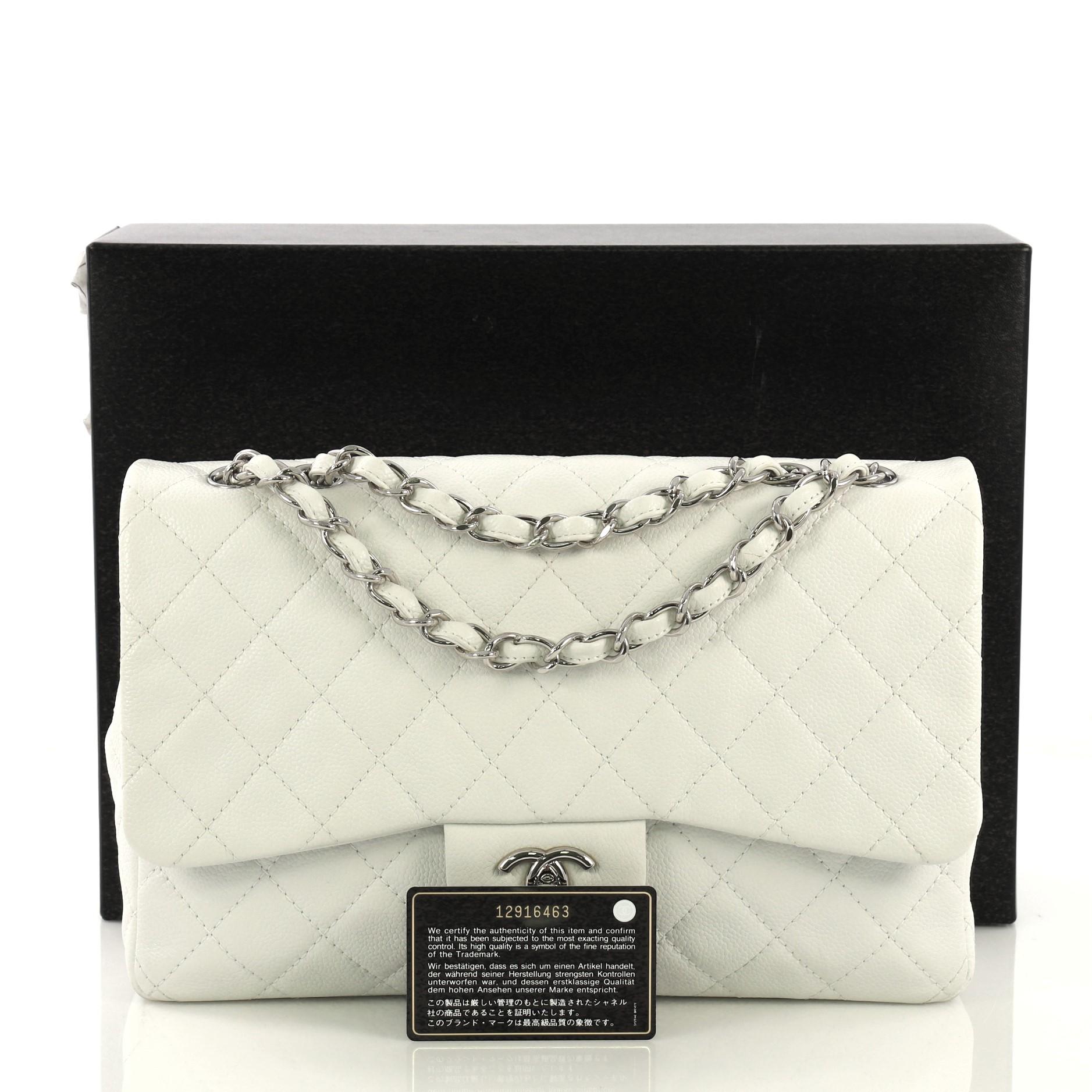 This Chanel Vintage Classic Single Flap Bag Quilted Caviar Jumbo, crafted in white quilted caviar, features woven-in leather chain link straps, exterior back slip pocket, and silver-tone hardware. Its CC turn-lock closure opens to a white leather