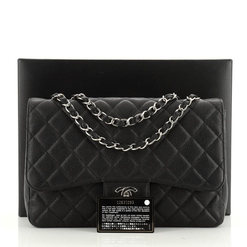 This Chanel Vintage Classic Single Flap Bag Quilted Caviar Jumbo, crafted in black quilted caviar leather, features woven-in leather chain link strap, exterior back slip pocket, and silver-tone hardware. Its CC turn-lock closure opens to a black