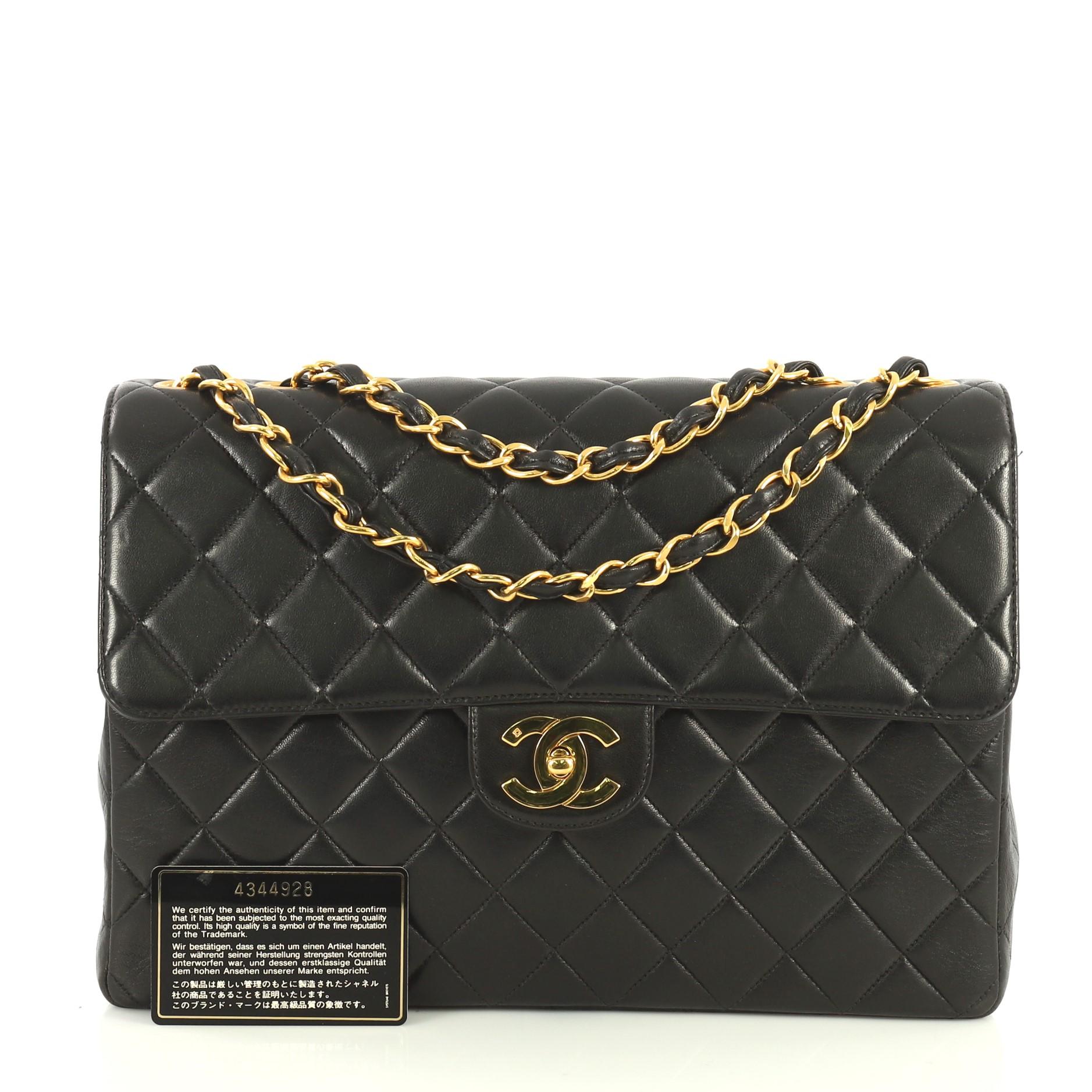 This Chanel Vintage Classic Single Flap Bag Quilted Lambskin Jumbo, crafted in black quilted lambskin, features woven-in leather chain link strap, exterior back slip pocket, and gold-tone hardware. Its CC turn-lock closure opens to a black leather