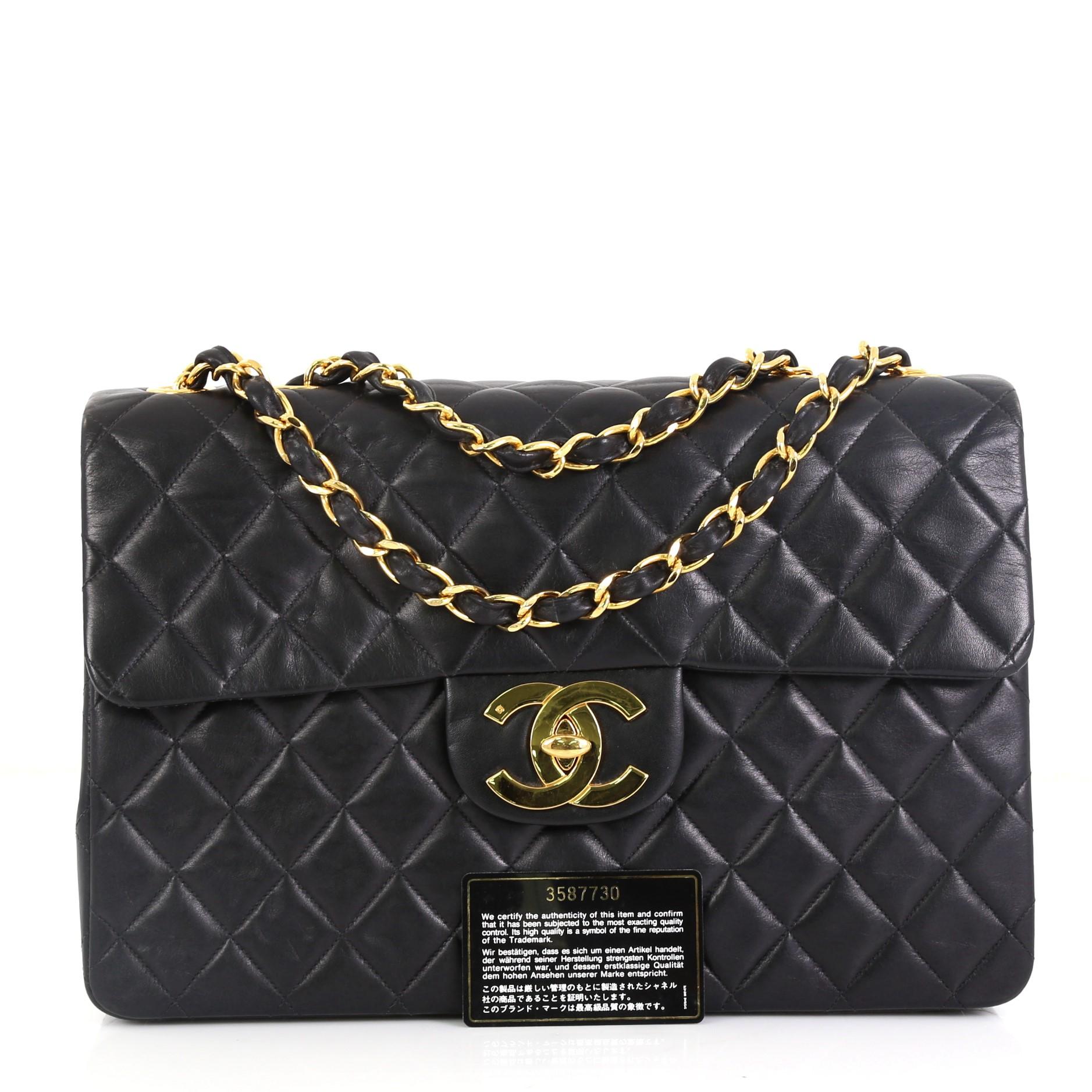 This Chanel Vintage Classic Single Flap Bag Quilted Lambskin Maxi, crafted in black quilted lambskin, features woven-in leather chain link straps, exterior back slip pocket, and gold-tone hardware. Its CC turn-lock closure opens to a red leather