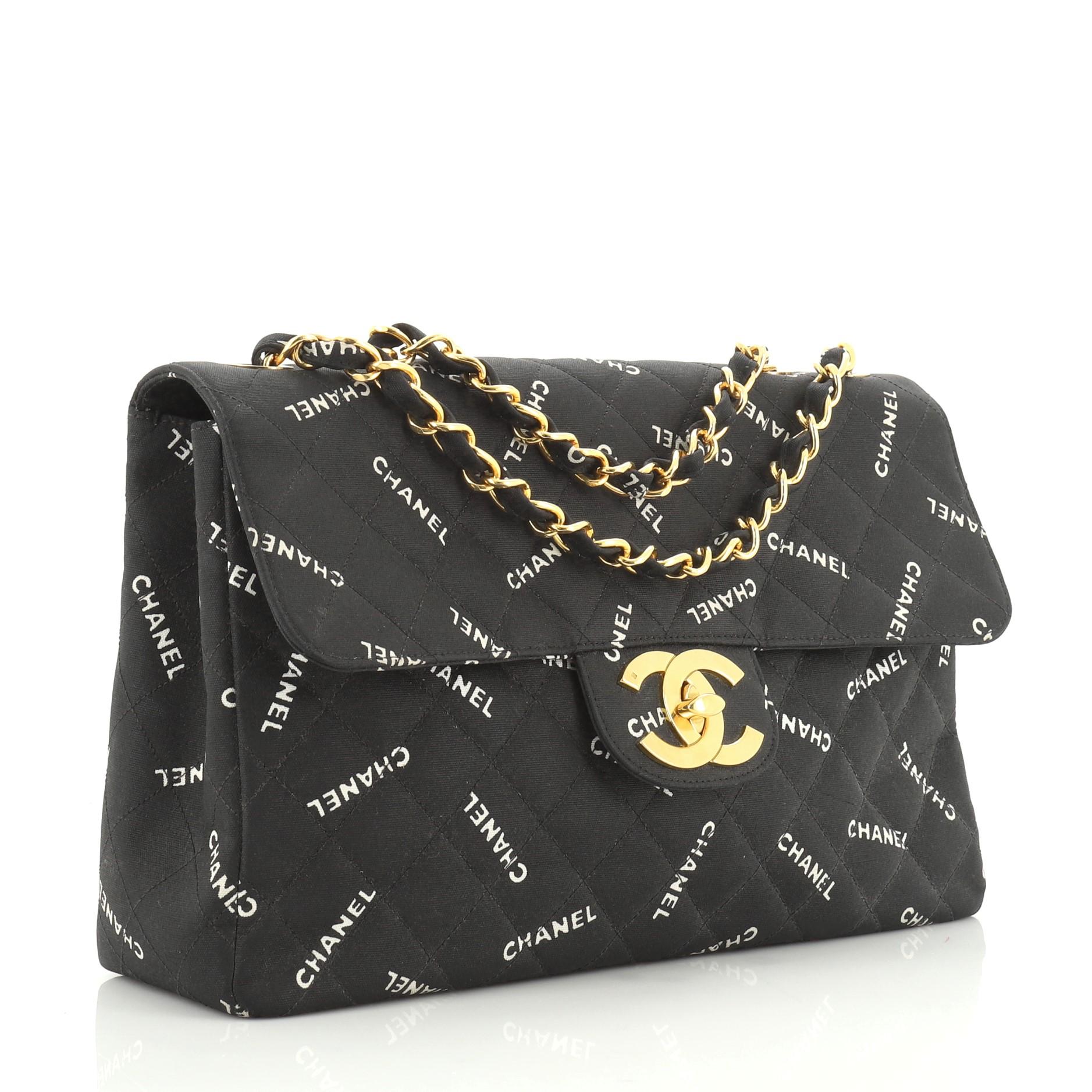 This Chanel Vintage Classic Single Flap Bag Quilted Printed Canvas Maxi, crafted in black quilted printed canvas, features woven-in canvas chain link straps, exterior back slip pocket, and gold-tone hardware. Its CC turn-lock closure opens to a
