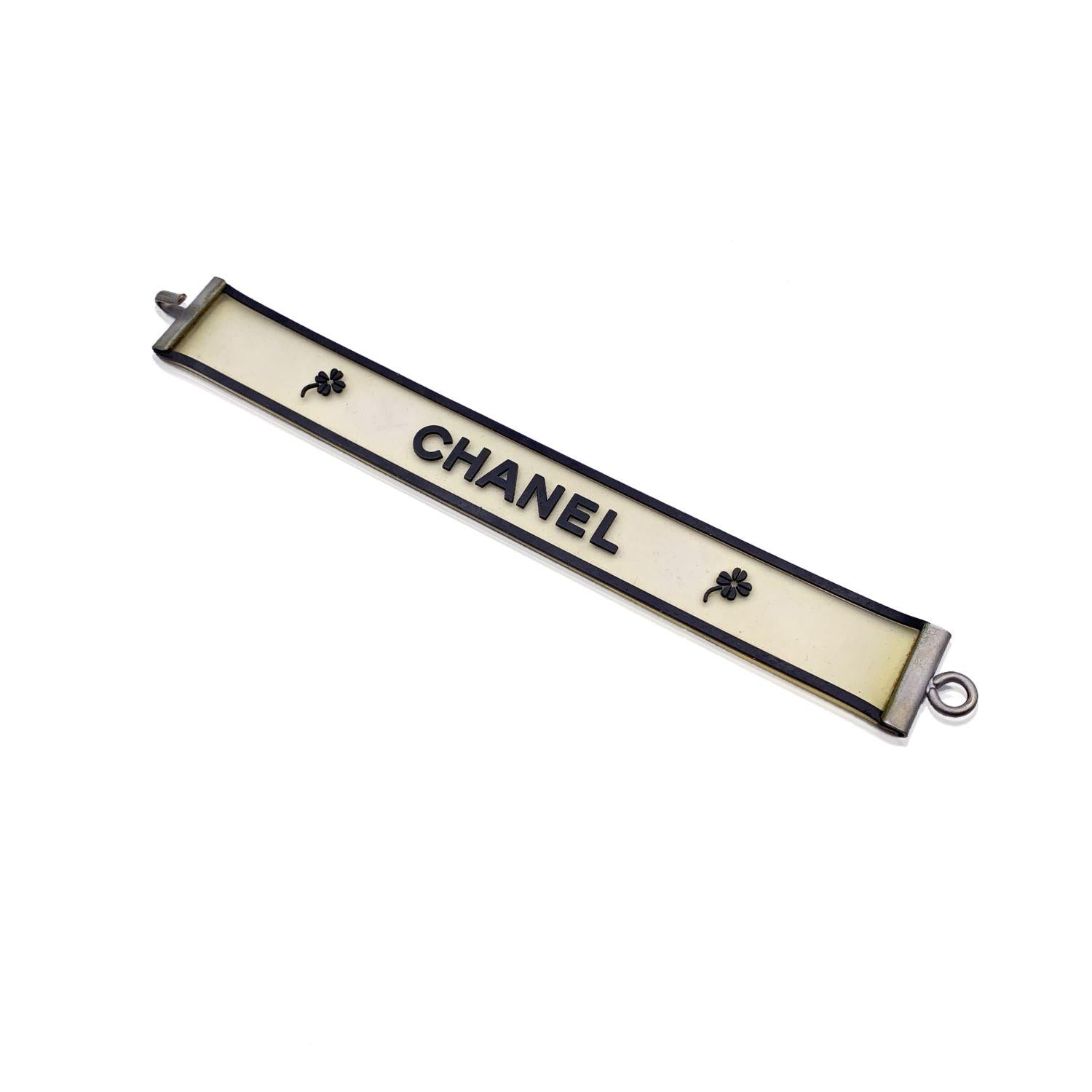 Lovely bracelet by CHANEL, crafted of clear and black silicone. It features black CHANEL writing between 2 quatrefoil. Hook closure 'Chanel 01 CC A Made in France' oval hallmark near the closure. Total lenght: 7 inches - 17.7 cm . Condition A -