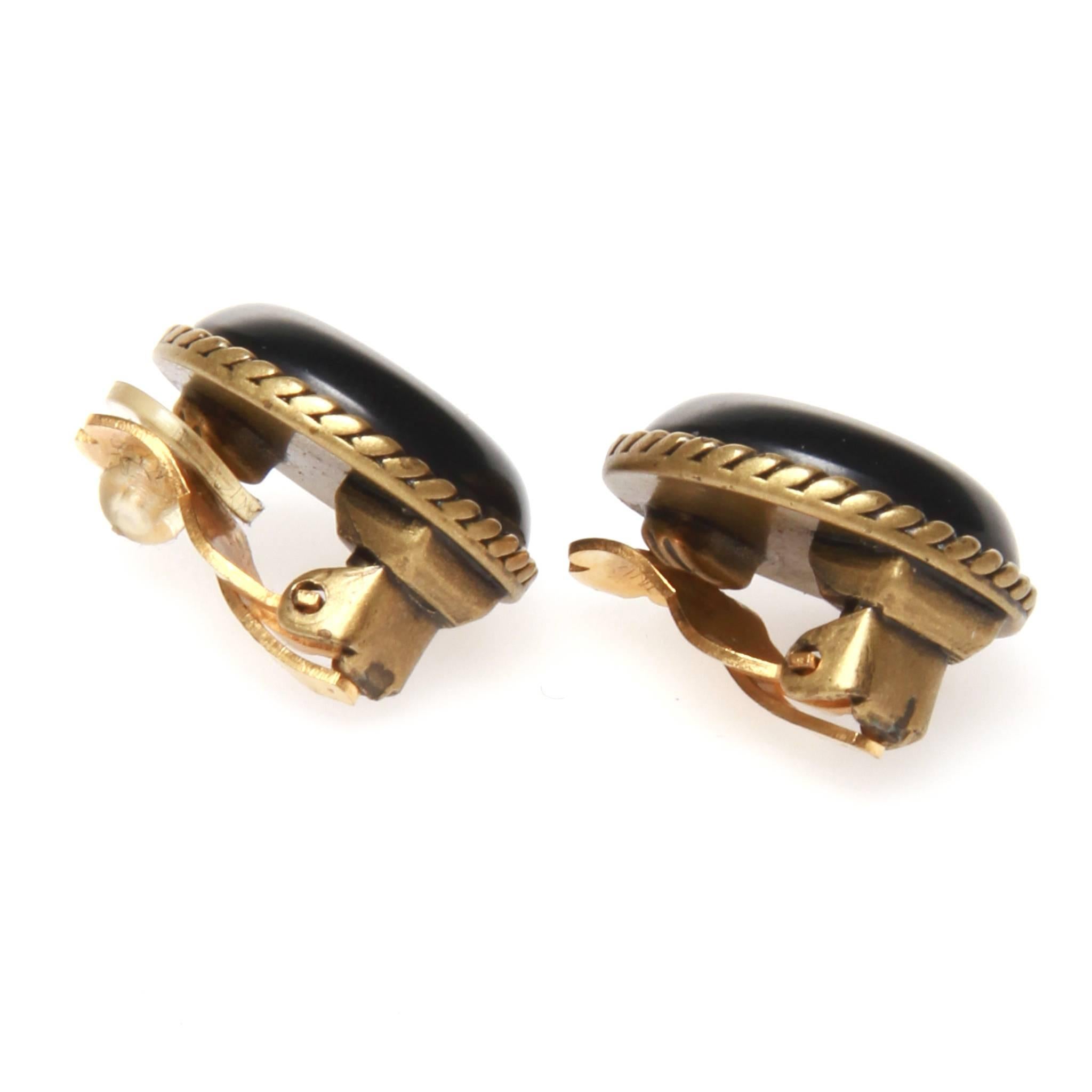 Chanel vintage clip on earrings featuring a CC printed on black resin and set on gold-tone metal. 