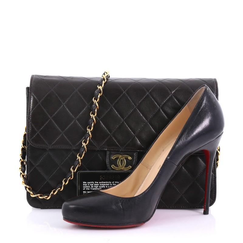 This Chanel Vintage Clutch with Chain Quilted Leather Medium, crafted in black quilted leather, features woven in leather chain strap and gold-tone hardware. It opens to a burgundy leather interior with zip pocket. Hologram sticker reads: 5389299.