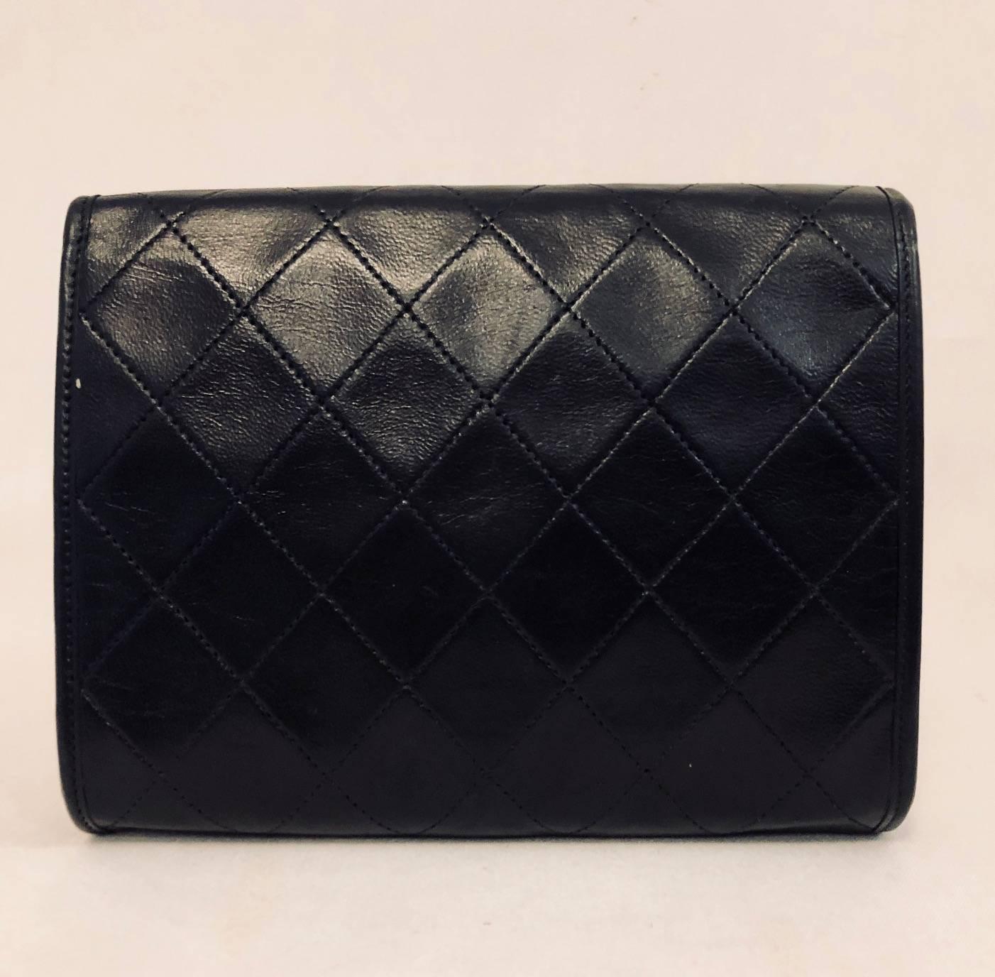 This vintage diamond stitched clutch bag was originally a shoulder style bag from the 1980's, but has since lost its strap.  The inside is lined in a thick black grosgrain and only has one single interior pocket.   It is stamped on the inside, on