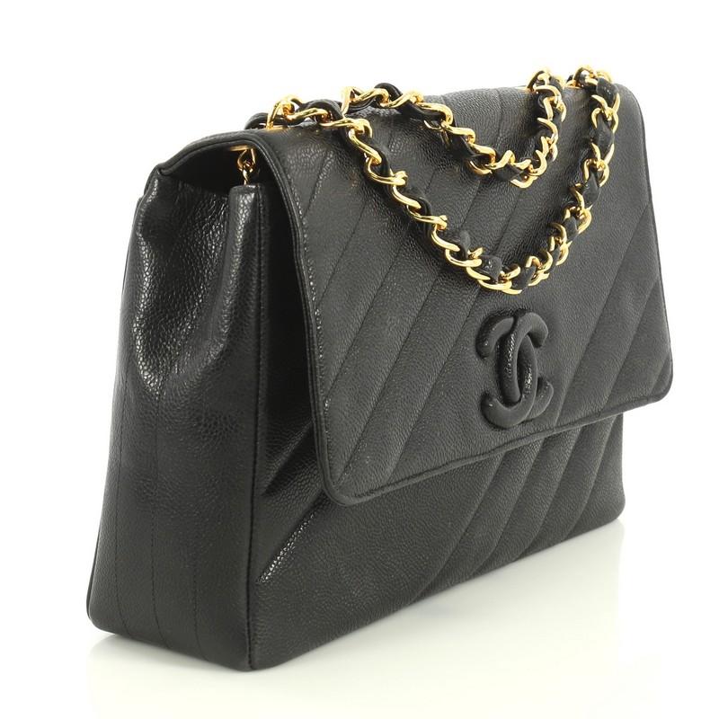 This Chanel Vintage Covered CC Flap Bag Diagonal Quilted Caviar Jumbo, crafted in black diagonal quilted caviar leather, features woven in leather chain strap, covered CC logo, frontal flap and gold-tone hardware. Its magnetic snap closure opens to