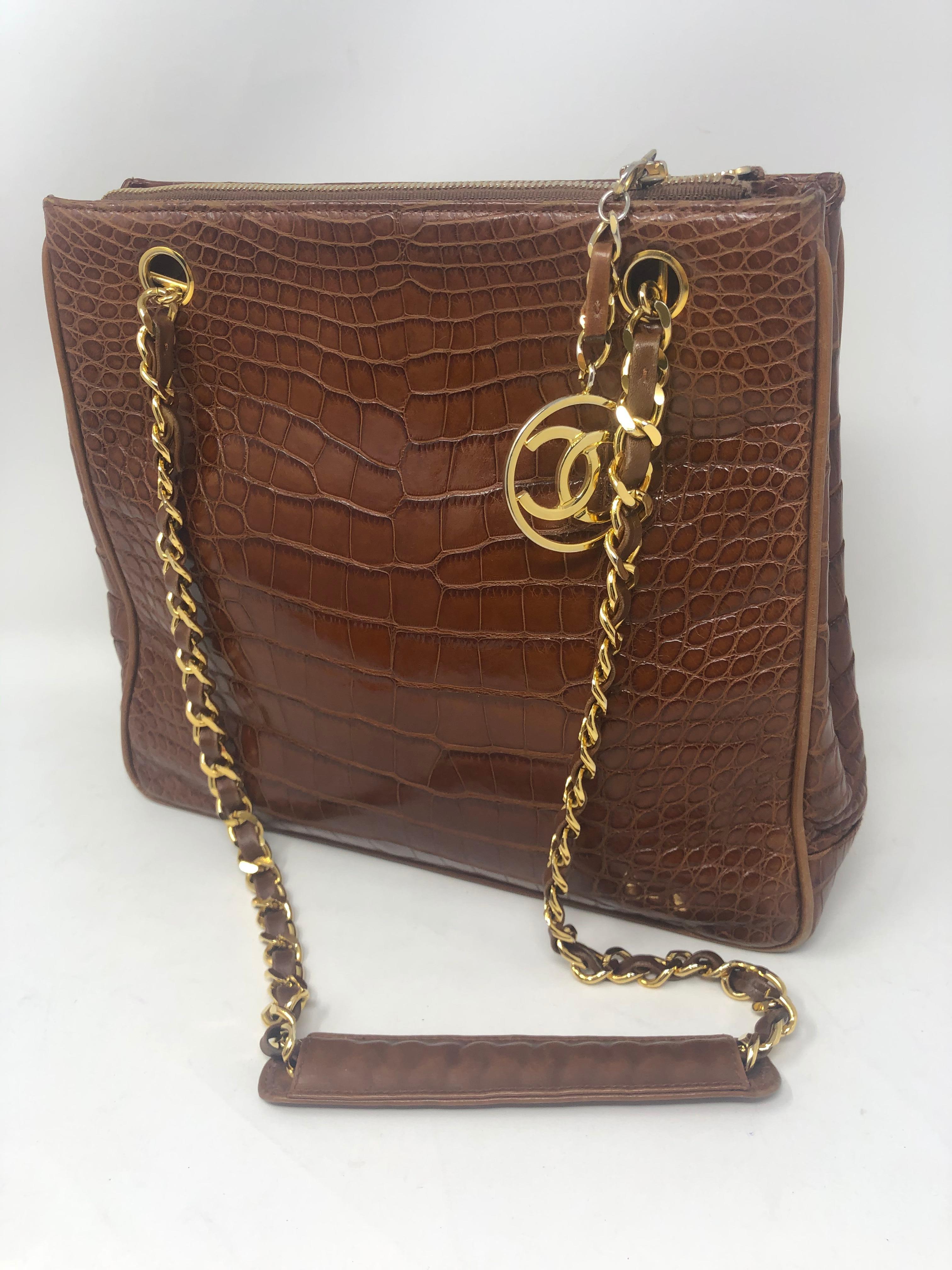 Chanel Brown Crocodile Handbag. Vintage crocodile bag with gold hardware. Excellent condition. Clean interior with all leather compartments. Beautiful croc skin tote bag with CC medallion hanging off bag. Rare crocodile for Chanel. Collector's
