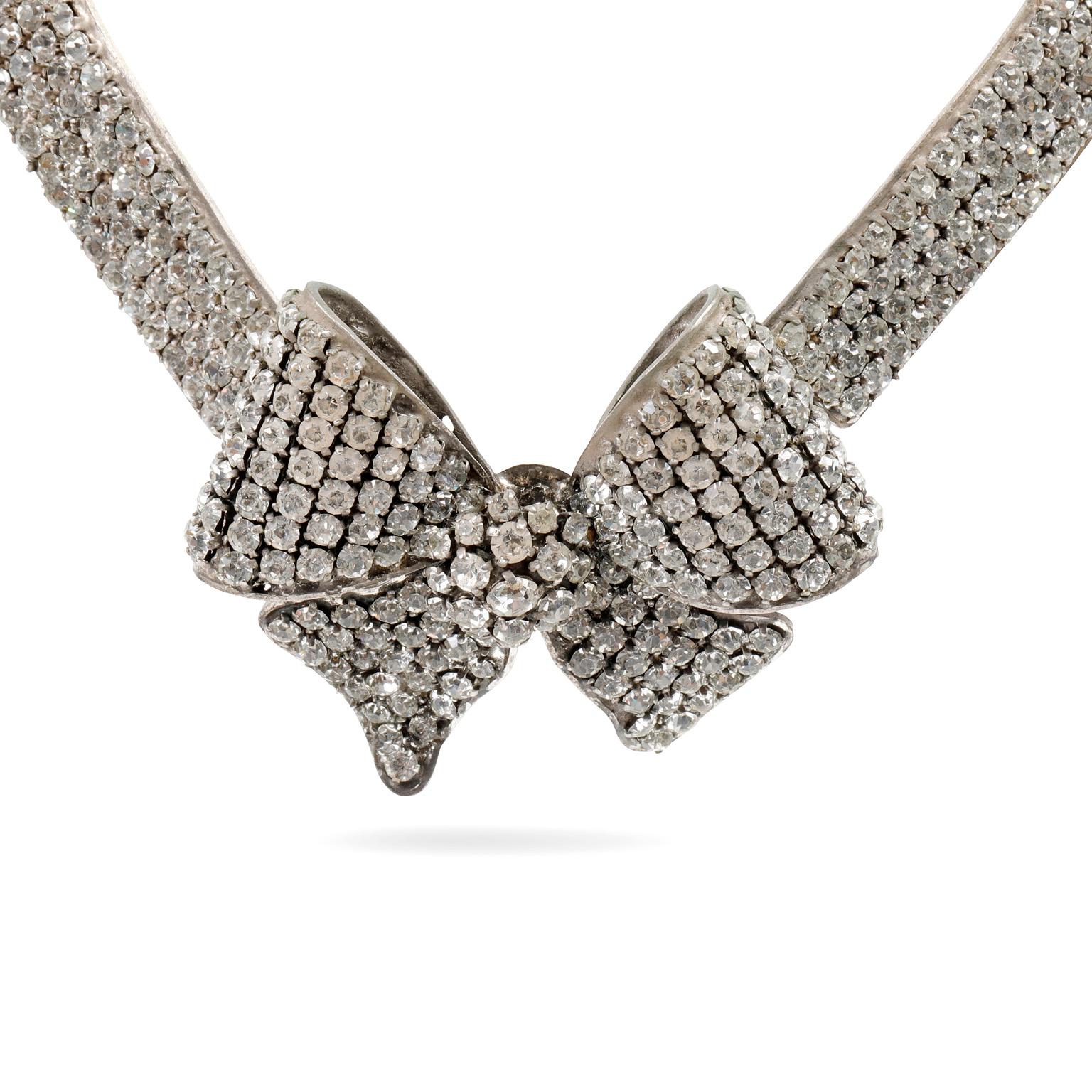 This authentic Chanel Crystal Bow Choker is in beautiful vintage condition from the Fall 1993 collection.  A rare and stunning statement necklace, it is a must have for collectors. 
Four rows of clear crystals culminate in a central crystal