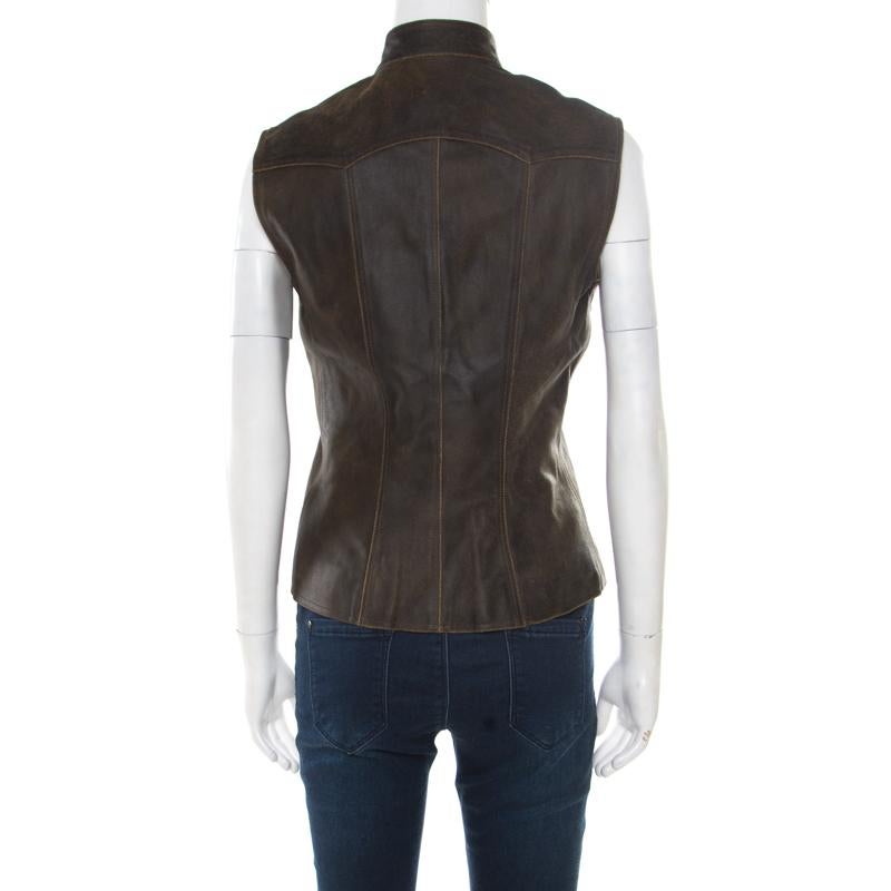 Let your closet experience a stylish addition with this vest from Chanel. It is well tailored from dark brown calfskin leather and features a buttoned fastening at the front embossed with the signature CC logo. It has a stylish silhouette,