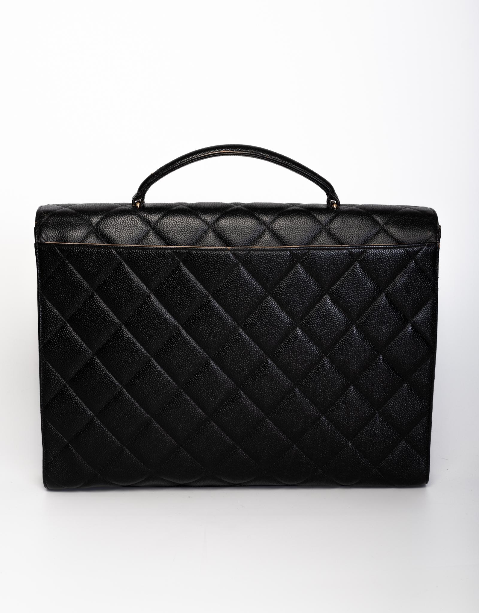 This Chanel briefcase bag is made with black caviar leather with signature diamond quilted stitching. Featuring gold tone hardware, a front flap with the signature interlocking CC turn lock closure, a sturdy top handle, a back full length slip